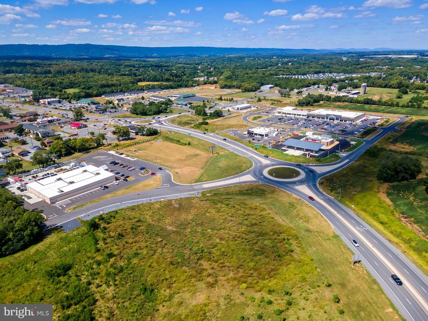 Development Opportunity of a Lifetime.  The 4th Corner of Commerce in Inwood WV located in South Berkeley County,  one of the fastest growing areas of the country conveniently located on the Interstate 81 Corridor between Winchester and Hagerstown, is now for sale.  Prime land for development of all types, as Berkeley County has no specific zoning, thus allowing the property to  be subdivided to accommodate different types of use. Located next to the newly built Food Lion, which is reportedly the 4th highest producing Food Lion in the country.  Inwood is the home to Proctor and Gamble, Knauf Insulation, Orgill, Clorox, Amazon, Eastern Regional Airport, Tabler Station Logistics Park and more. Conveniently located less than 1 mile from Interstate 81 which has current traffic counts at approximately 70,000 vehicles a day which provides unmatched exposure across the Eastern United States from Tennessee to Canada. Property has access road/round about project completed, main line sewer, water and gas installed.   **This property is multiple parcels.  See documents for tax records.  **Please note:  Price listed is a placeholder and not the price for the entire parcel if purchased in it's entirety..  As parcels have different values according to location, each parcel that is desired by developer will be priced accordingly.  See agent for details.  Pricing listed is not  price per acre for the individual parcels.