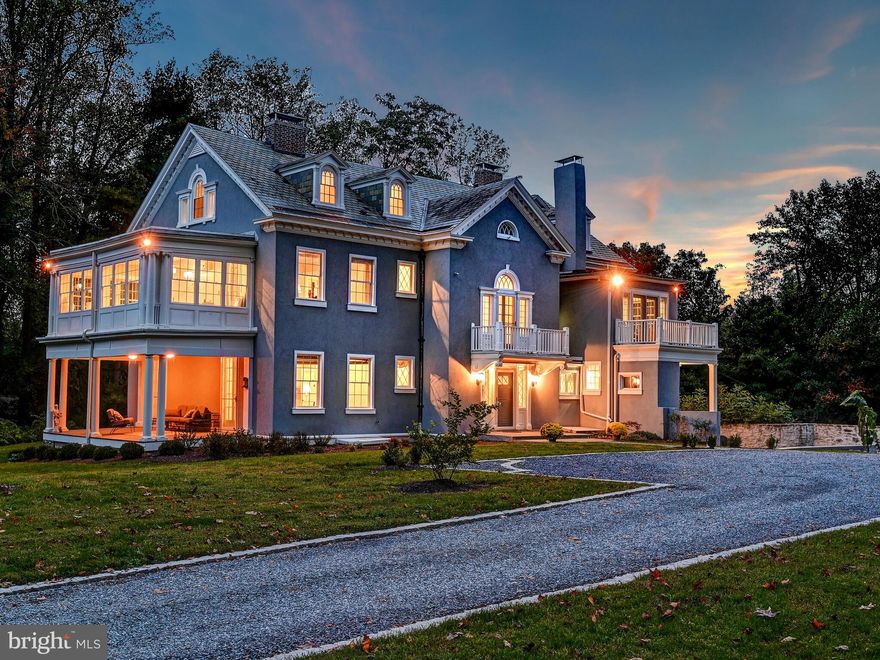 Located in the Falls Road corridor of the Greenspring Valley this stunning Brooklandville estate called “Glencliffe Manor was built by the esteemed architectural firm Mottu & White that also designed Tyrconnell of Woodbrook and Friends School. The present owners masterfully restored and renovated, sparing no expense in significant upgrades keeping the historic elements to blend seamlessly with today's modern needs and style. 
You will never tire of being greeted in the stunning grand foyer with its crackling fireplace,  heart pine floors, 11-foot ceilings with exquisite moldings, two-story staircase, and views through to the lovely outdoor circular covered patio for delightful entertaining. Guests can flow easily to the spacious dining room and sophisticated contemporary-style living room each with wood burning fireplaces. A main floor office is tucked in a quiet area of the main level with generous-sized windows, crafted millwork, a fireplace, and French doors to one of the many side porches. A country kitchen with 42-inch cabinets, granite counters, an island, breakfast bar, built-ins, coffee station, and a stainless farm sink has been thoughtfully designed. The kitchen flows to a breakfast sunroom/family room wrapped in windows ideal for hosting informal everyday dining and casual gathering overlooking the garden area. Enjoy two upper levels consisting of six spacious bedrooms and four renovated baths some with attached porches or balconies. The primary bedroom is a welcome retreat with its wood burning fireplace, sitting porch OR office and dressing area, and an attached bath with spa tub and shower.  Enjoy evenings on the circular porch, or walk along the grounds and wild flowers and collect fresh eggs from your own hen coop.  This house is ready to move in with all the updating done including baths, kitchen, new windows, new two water heaters, redone stucco exterior, 2016 plumbing and electrical systems, and an energy-efficient heating and cooling geothermal system to keep all costs extremely reasonable!