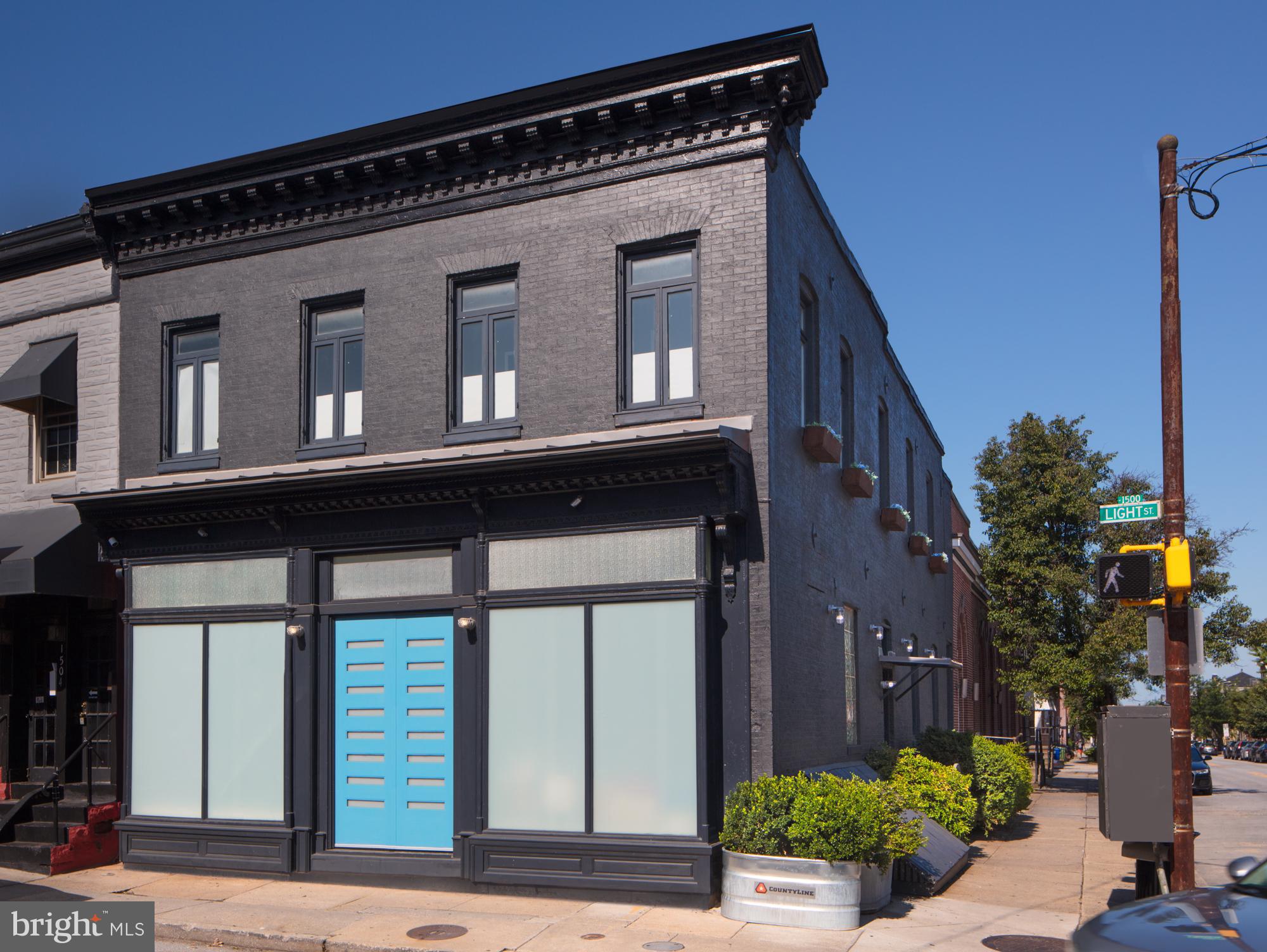 ** Due to multiple offers, my clients have set a deadline for highest and best offers by this Saturday the 12th at 8pm. My clients reserve the right to accept an offer at any time*** A rare and remarkable Federal Hill area home. Last on the market over two decades
ago, you’ll find over 3000 sq’ of open floor-planned excellence awaiting you in this
standout home. At over 25’ wide, one could playfully call it a Federal Hill double-wide.
Previously the location of Mack's Hardware Store in the 1970s and later, the art studio
of the noted American artist Salvatore Scarpitta, this home sensitively retains a sense of
its own rich history even as it’s been rendered notably contemporary in every way. With
the restored, authentic storefront, hardwood floors, natural slate tile, walnut
wood throughout, glass galore and soaring, original tongue and groove ceilings, the
space is notably grand, light-filled, airy, and inviting.
The large, bright Kitchen is a true centerpiece—featuring custom concrete countertops,
stainless steel appliances, a four-stool bar, and a custom layout designed for easy meal
creation and effortless entertaining. Whether you're cooking for two or twenty, this
kitchen handles it all. Next to it, there’s plenty of space for a full-sized dining table or a
cozy conversation area, depending on how you love to live and gather. The Kitchen
opens to a huge loft style Living Room and Library space with a full wall of shelving and
a custom library ladder—perfect for displaying your favorite books, art, or curated
collections. Beyond that is the glass enclosed breezeway and a welcoming main entry.Â
Included on the main level you will find a convenient Powder Room, Pantry, and a
generous Mudroom.Â
On the second floor you will find 3 large Bedrooms and 2 Full Baths. The Primary
Bedroom includes a Full Bath complete with custom walk-in shower, claw foot tub, and
a custom double vanity. A large Walk-in Closet and a second Office space are also
included in the Primary Suite. The second Bedroom includes double closets and plenty
of built-in storage, and the third Bedroom includes a large closet and private little
Reading Nook is suspended playfully over the main stair. A super convenient Laundry
space with a full sized washer and dryer is also located on the second floor. Soaring
high ceilings and huge windows bathe the second floor in natural light. From here,
follow the custom ship ladder stairway to the roof for amazing views and relaxation.
Returning indoors and heading downstairs, the expansive Basement offers full-height
ceilings throughout. The open stair leads to a glass-walled office space, a workout
room, a large storage area, and a 400 square foot volume the current owner uses as a full
woodworking shop. The basement bath area is currently set up as a bike wash and
storage room to suit the needs of the current owner, but could just as easily be used as
a pet wash area or converted back to a full bath.
This wonderful home is just waiting for its perfect people to come enjoy everything it has
to offer. Whether you’re looking for a spacious house, a perfect live-work space or the
ideal spot for your nascent business venture, this place has it all. This super location is
walking distance to literally everything you want to experience in Federal Hill and is
surrounded by permit-only parking. A pool membership to Otterbein Swim Club is also included
with this home, the waiting list for which is currently extended through 2029!