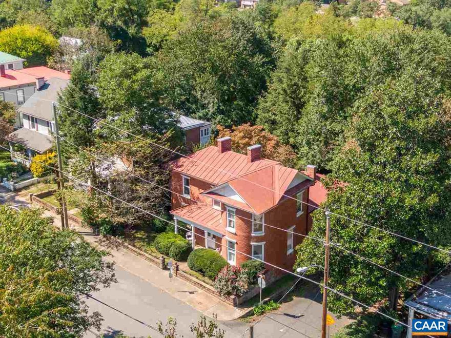 Live in the heart of the city, within walking distance to the Downtown Mall, Ix Art Park, UVA Hospital, and much more. Available Aug. 5, 2024. This is a beautifully restored, 118-year-old brick home with a metal roof, located on a corner lot of a quarter-acre just a short walk from all things C-ville. Enjoy special architectural details like a curved facade, original hardwood floors and windows, attractive mantels and hearths, and soaring ceilings. This light-drenched home was built by brickmason Eston Updike for his family in 1906. It has been renovated and restored throughout the years, including the creation of a modern kitchen, a two-zone heating and cooling system, and three separate conditioned attic spaces for storage. There is also an unfinished basement. Enjoy the outdoors from a terraced back yard. Owner/agent.