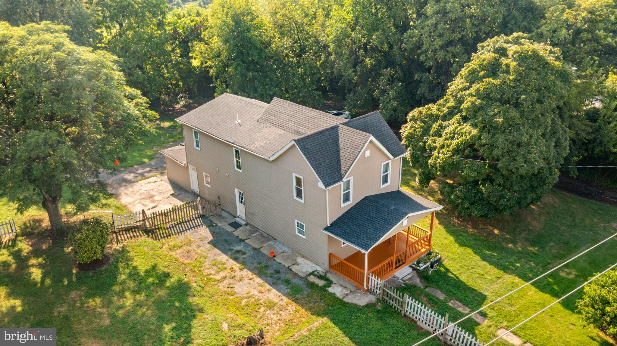 Old-timey 1920 home that was completely rebuilt in 2018! The main part of the house is spacious with living room & dining room as you enter from the commodious front porch. Kitchen is towards the back & not far from the back entrance. Guest bath is across from the basement entrance. All bedrooms and the full bath are located upstairs. Wood flooring throughout for easy maintenance. The downstairs wood floors are extra thick, since they get more use. The basement is dry and clean for the washer & dryer, water heater and storage. There is a 1-bedroom in-law suite accessible from the outside that has another kitchen, a bath and storage. This could be for extra family, a rental unit or an office for a business. Very large lot with off-street parking for many vehicles. Plenty of space to build another home facing the street and/or many garages in the back. Fruit trees and a garden were maintained by the current owner. There is a bumper crop of peaches and apples this year. The chicken coop and basketball hoop convey, but can be removed, if not wanted by the new owners. If you need a house with plenty of space inside and out, come and take a look.