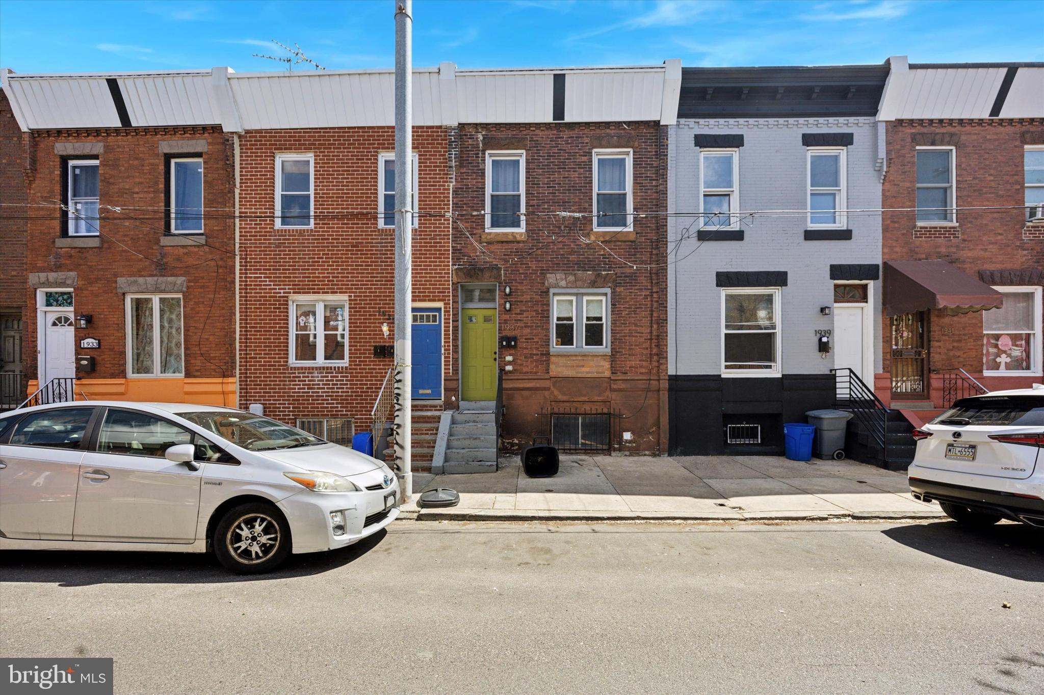 This charming duplex, with a strong rental history, features two 1-bedroom, 1-bathroom units, each showcasing original hardwood floors throughout. Updated in 2017, both units blend modern amenities with historic charm. The first-floor unit offers a spacious, open-concept living and kitchen area with exposed brick, while the rear bedroom opens to a large private patio, ideal for outdoor relaxation. Basement access provides additional storage and a laundry area. The second-floor unit has a separate kitchen and living space, with the rear bedroom leading out to a cozy balcony. Situated in the desirable Point Breeze neighborhood, near West Passyunk, this property is conveniently located near the 23rd Street shopping area, Broad Street, and public transportation, including easy access to bus routes.