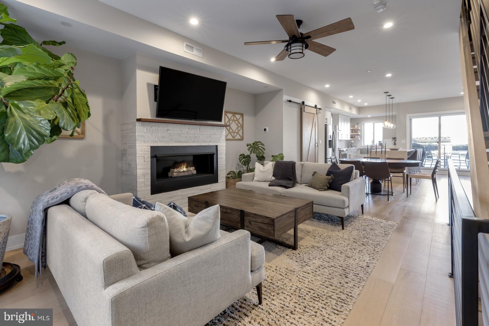 A rare Fishtown opportunity: 3 bedrooms, 3 full baths, 1-car off-street parking including an oversized garage, and 4 YEARS REMAINING ON THE TAX ABATEMENT & OPTION FOR SECOND DEEDED PARKING SPOT— all on a quiet block just steps from Frankford Avenue.
Built just 6 years ago, this 2,400+ sq ft home offers a turnkey layout designed for modern city living — with hardwood floors throughout, custom finishes, and a private rooftop deck with skyline views.
First Floor
Spacious entryway, guest bedroom, full tiled bath, and access to a finished basement — perfect for a gym, media room, or flex workspace.
Second Floor
Open-concept main level anchored by a chef’s kitchen featuring white cabinetry, stainless steel appliances, a bar sink, and a striking waterfall-edge island with seating. The kitchen flows into a sunlit dining area and generous living space with a gas fireplace framed in stone tile. A private patio off the kitchen adds a welcome outdoor retreat.
Third Floor
Two well-proportioned bedrooms, including a rear-facing primary suite with dual closets, built-ins, and a spa-inspired bath featuring a frameless glass shower and double vanity. The front bedroom includes its own full en-suite bath. A wet bar with wine fridge leads to the rooftop deck with sweeping Center City views.
Additional highlights: option for second deeded parking spot, oversized garage with storage, dual-zone HVAC, recessed lighting, and premium fixtures throughout.
Neighborhood Perks
Walkable to LMNO, Riverwards Produce, Loco Pez, Green Eggs Café, and minutes to Palmer Park, Konrad Square, I-95, and the Market-Frankford Line.
