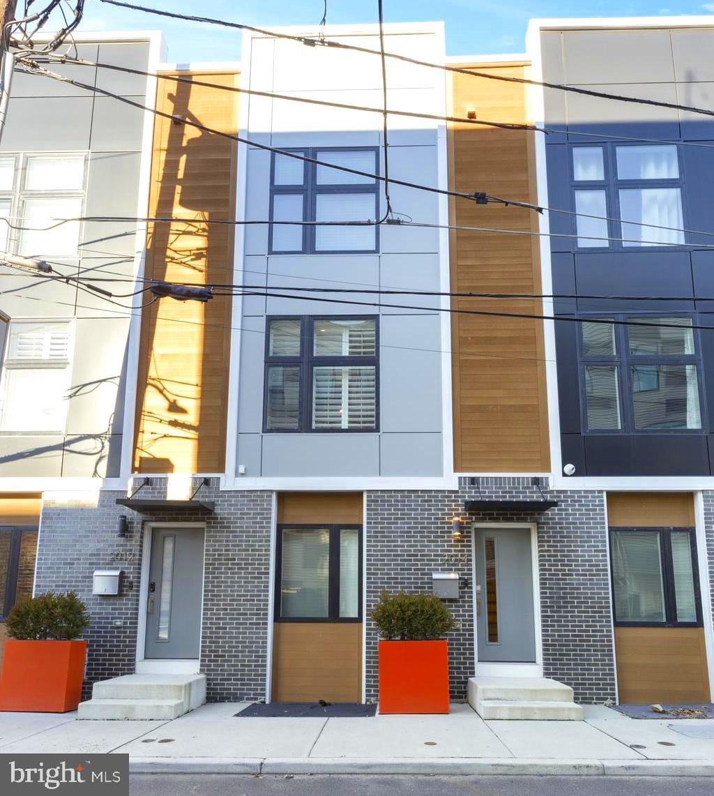 Welcome to modern city living at its best—2014 Blair Street in vibrant Fishtown.
Listing at $739,900, this exceptional 2,400 sq ft, 3-bedroom, 3-bathroom townhouse was built in 2019 and features approximately 4 years of remaining tax abatement, offering a savvy blend of value and style. Enjoy a thoughtfully laid out first floor with a private guest suite and a finished basement—your ideal flex space. The second floor beckons with an open chef’s kitchen boasting a striking waterfall-edge island, stainless steel appliances, and sweeping living and dining areas with a cozy stone gas fireplace. Step outside to your private patio—perfect for al fresco dining or morning coffee. Retreat to the third floor, where the rear primary suite offers dual closets and a spa-like bath, while the front en-suite bedroom, wet bar, and rooftop deck with skyline views elevate entertaining or quiet relaxation. Additional highlights include one oversized garage (with potential for a second space), hardwood floors, recessed lighting, dual-zone HVAC, and premium fixtures throughout. Nestled just steps from Frankford Avenue, this home brings Fishtown’s best right to your doorstep—restaurants, grocers, parks, transit, and more. Don’t miss this rare opportunity to own a turnkey, contemporary gem in one of Philly’s most sought-after neighborhoods.