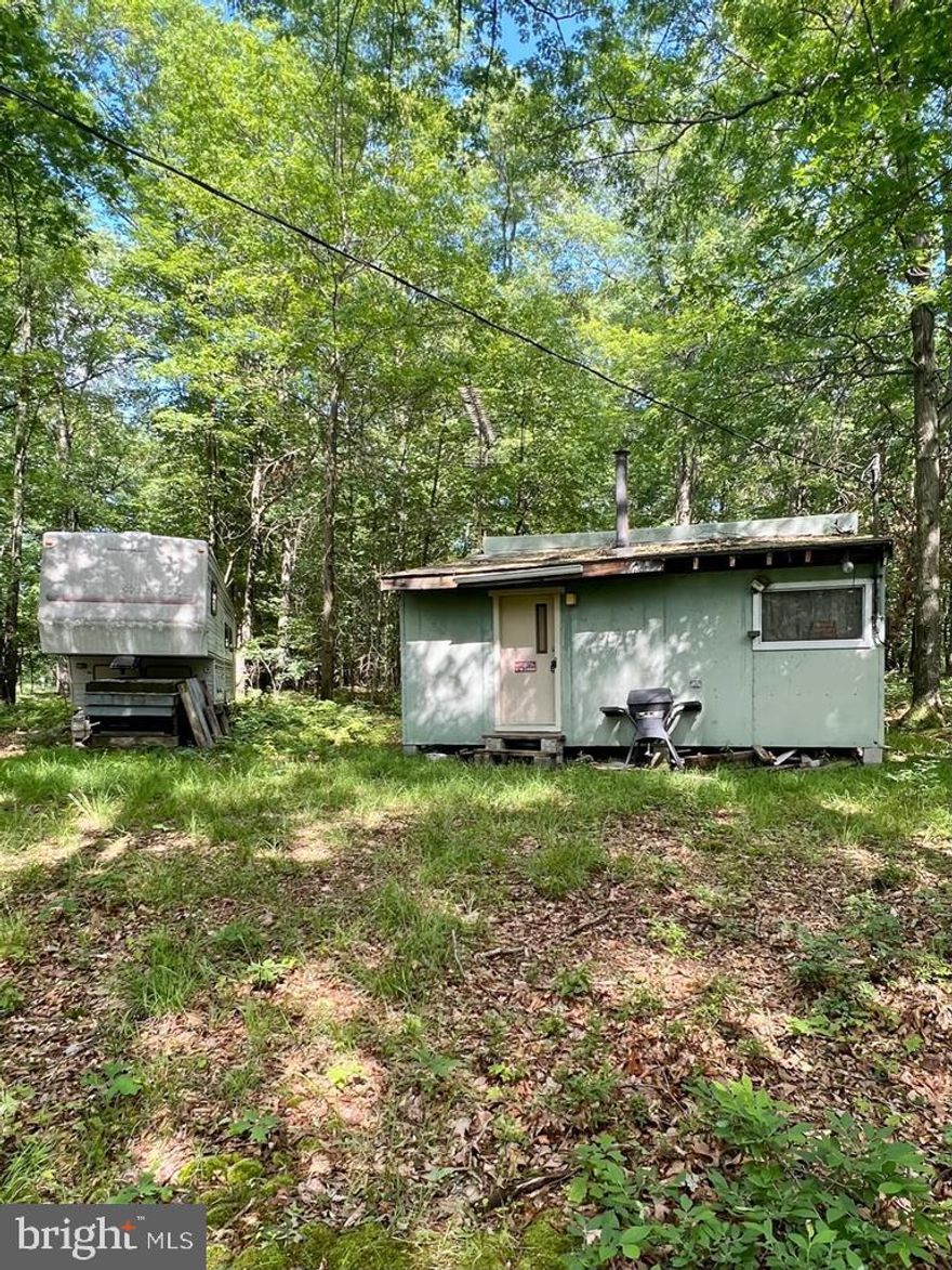 Needing a little love but boasting with potential this little camp has endless possibilities. Sitting on a half acre of wooded land you could turn this camp into an AirBnB or keep for recreational use to enjoy with family and friends. Less than 10 minutes from Black Moshannon State Park, and only 30 Minutes to state college. A fifth wheel camper is included in the sale providing additional sleeping space for your hunting group!