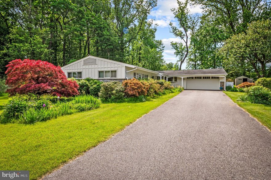 Welcome to 618 Lake Dr, tucked into the established Fellowship Forest community, still shaped by its estate origins rather than typical subdivision planning and known for its privacy, spacious lots, and mature trees. This 4-bedroom, 2.5-bath home offers a rare blend of architectural character, sun-filled spaces, and the ease of primarily one-level living with additional flexible space on the lower level.

The living room is truly a moment, featuring vaulted ceilings with exposed beams, a statement wood-burning stone fireplace, and a dramatic wall of floor-to-ceiling windows overlooking the 6th green at The Country Club of Maryland. The living area flows seamlessly into the dining area and kitchen, which features granite countertops and an oversized island.

The main level continues with 4 spacious bedrooms and a hall bath with a skylight. The primary suite features an updated en-suite bathroom along with a generously sized dressing area and closet space.
The lower level offers the best of both worlds with a partially finished area complete with a half bath, as well as a dedicated laundry area and abundant storage space — with plenty of opportunity to further expand the finished footprint if desired.

The outdoor space continues to impress with lush landscaping, a covered front porch with paver flooring, a concrete patio overlooking the backyard, and a fenced side yard. Parking is plentiful with an attached 2-car garage and a paved driveway accommodating at least 4 vehicles.

Featured updates include the roof (2016), primary bath renovation (2018), driveway replacement (2018), rear patio (2020), kitchen patio door (2022), and refrigerator (2025).

With timeless architectural details, incredible natural light, and a setting that feels both private and connected, 618 Lake Dr offers a truly special place to call home.