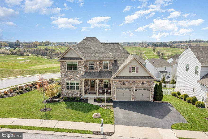 The living is easy in this immaculately maintained two-story home situated on a premium corner lot in the highly desirable golf course community, The Views at Bridgewater. This custom 2,294 sq. ft. home features a bright and open floor plan with lots of natural light and upgrades throughout including stunning engineered hardwood floors, a custom front door and upgraded stone exterior, a personal lamppost and mailbox, a professionally landscaped lot, custom blinds, upgraded bronze fixtures throughout, and a carefully designed floor plan that will surely check every box on your list. The main floor offers a warm and inviting space, perfect for entertaining family and friends, a dream eat-in kitchen with granite countertops, a large center island, and ample cabinetry, a spacious living room with a cozy gas fireplace, a rear sunroom perfect for morning coffee and taking in the golf course views, a dedicated office, a main floor laundry/mudroom with cabinetry, shelving, and a utility sink, and so much more! The spacious owner's suite rounds out the main level and features a large walk-in closet and a spa-like ensuite bath with double sinks and a large walk-in tile shower. The second floor features a bonus loft, offering an ideal place for an additional living area or flex space, two additional bedrooms including one with a walk-in closet, and an additional full bathroom. The lower level is unfinished yet filled with an impressive amount of natural light, featuring a walk-out basement with a glass slider door, offering generous storage and the potential to create additional living space tailored to your needs. Additional features include 2x12 floor joists for added support, two water heaters, a radon mitigation system, a whole house security system, and an upgraded digital nest thermostat, all offering peace of mind for years to come. A three-car-wide driveway and a beautiful epoxy-coated garage with built-in shelving provide ample room for cars, tools, and hobbies. The sunroom boasts Garrety glass and leads you to a fenced-in backyard and a private, covered patio offering the perfect space to relax, entertain, and take in the gorgeous views of York County. Located in Dallastown School District and just steps from Bridgewater Public House restaurant, this home offers unbeatable convenience to local dining, shopping, I-83 access, and all the amenities York has to offer. A truly must-see home!