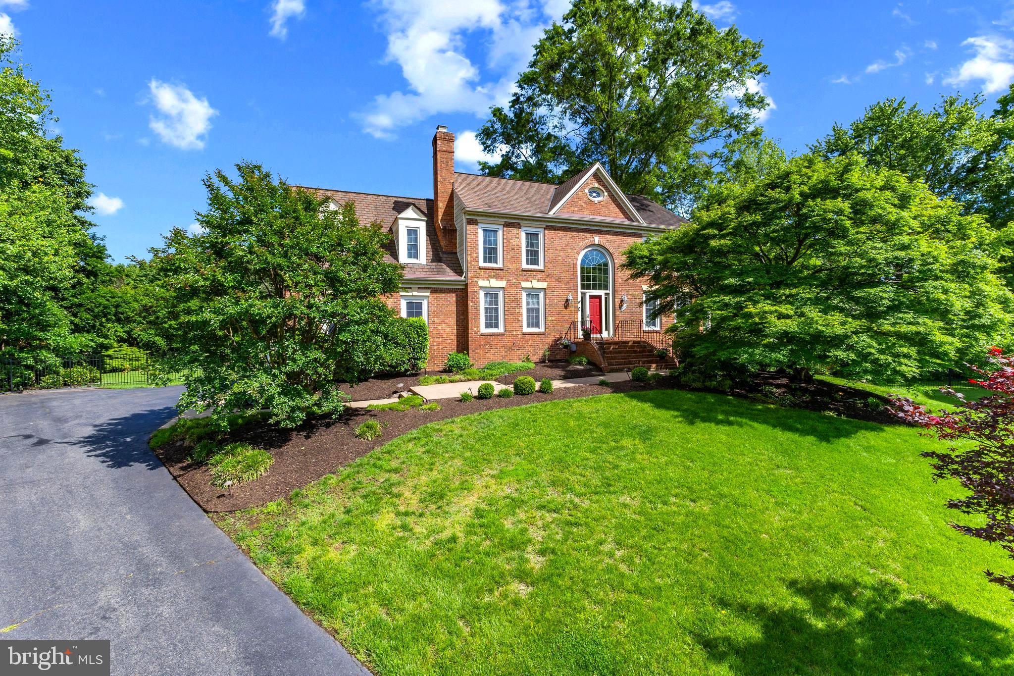Welcome to 2200 Traies Court, a beautifully updated colonial home offering 5 bedrooms, 3.5 bathrooms with over 5100 sqft of living space! Situated on a quiet cul-de-sac in Alexandria's Kirkside neighborhood, this property features a spacious interior with updated bathrooms, open kitchen, a peaceful sunroom, ample storage space, and a gorgeous private backyard. The main level offers elegant hardwood floors and detailed crown molding throughout with a front-facing office featuring built-in shelves, a welcoming living room, formal dining room, and an eat-in kitchen overlooking the vaulted family room. The sunroom is filled with natural light from floor-to-ceiling windows for a tranquil setting year-round. The spacious kitchen features stainless-steel appliances, a central island with table space, and direct access to a cozy family room complete with a gas log fireplace, elevated ceiling, and walk-out to the expansive deck. Upstairs offers 4 bedrooms and 2 full bathrooms. The primary suite features high ceilings, Palladian window, carpeted flooring, ceiling fan, and a walk-in closet. The recently updated ensuite bathroom includes a glass-enclosed shower and a free-standing tub, with private water closet. The hall bathroom is also beautifully updated with a dual vanity, soaking tub, and separate glass shower. The fully finished lower level expands the home’s livability with a versatile recreation room that opens to the backyard, a 5th bedroom, a full bath, and a hobby room/storage space. In addition to the large recreation room, enjoy a the dedicated gym complete with floor-to-ceiling mirrors and separate fully finished room could be used as a media room or storage space. Outdoors, the property offers a large, flat backyard bordered by mature landscaping, ideal for both entertaining and relaxation. A generous deck off the kitchen level provides ample space for outdoor dining and gatherings, with double stairs leading down to a flagstone patio and lawn. The rear exterior features durable Hardie plank siding, invisible fence, in-ground sprinkler system, and an oversized two-car garage. Significant recent upgrades include a brand-new HVAC system on the upper level (2025), new floor-to-ceiling windows in the sunroom (2025), new washer and dryer (2024), nearly all kitchen appliances updated in 2024 and 2025, and newly repointed front brick stairs (2025).