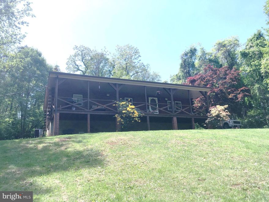 Log Ranch home only 5 minutes to I-66, Yet private and backs to trees! Brand New Central Air & Heat System! Wonderful, large front porch to just sit and enjoy nature. Mature trees surround lot, so it's very private. 3 bedroom 1 bath home. Has two wood burning wood stoves and gas stove so no electric no problem! Newer Roof and hot water heater. Basement. New Refridg. Home sit on 1 acre.