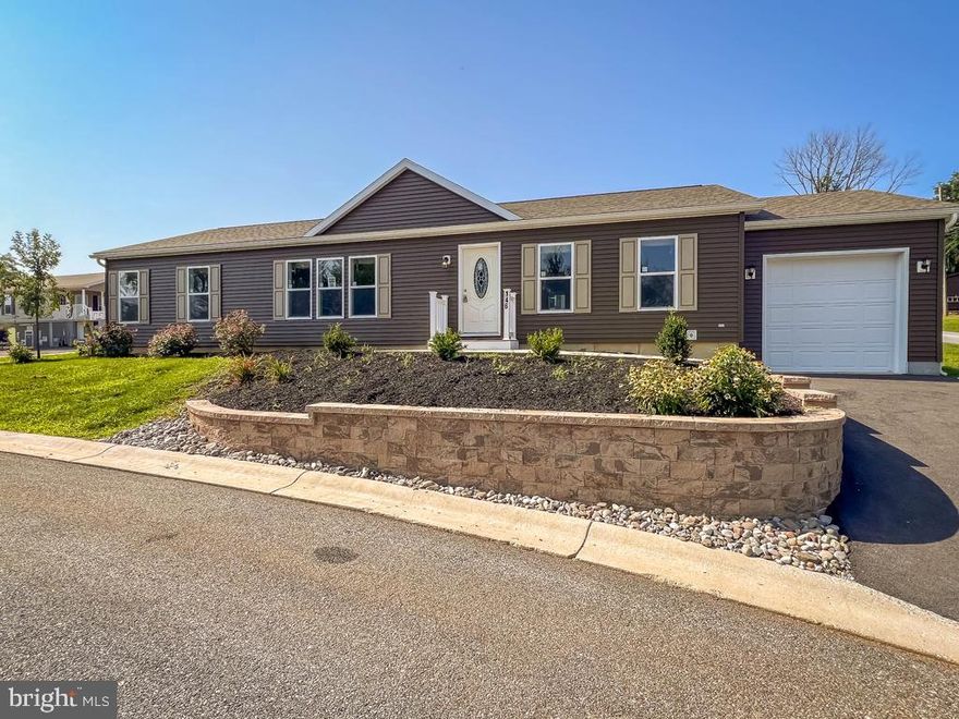 Brand new model home in new 55+ community.  This three bedroom home offers a spacious kitchen with many upgrades including oversized island, tile backslash, recessed lighting and upgraded appliances that open to the spacious living room for that open concept appeal. The sliding glass doors from the dining room open to a concrete patio for outdoor entertaining.  This home also has an additional office/den, utility/laundry room that is attached to a 12X24 garage. The master suite finishes this beauty with a large walk-in closet and a walk-in corner shower, 36″ vanity and high rise elongated toilet.  The color palette in this charming home is so warm and inviting anyone would want to call this home. With two full baths and a walkiin shower in the main its designed for modern living.