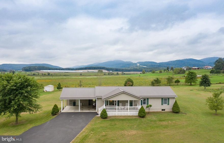 Welcome home to this one level rancher with just over 2 acres. Enjoy sitting on your oversized front porch with stunning mountain views. Inside you will find a kitchen made for the home chef/baker with ample counter space and eat in kitchen  area equipped with new stainless steel refrigerator and gas stove. In addition to the spacious living/dining area, the main level also includes 2 additional bedrooms, full bath and a master with en suite that includes a walk-in shower. Full size walkout basement with potential of two additional bedrooms is a bonus! New detached garage and new heat pump with propane as a backup. Close to commuter routes but far away enough to enjoy country living. This home won't last long, schedule your showing today!