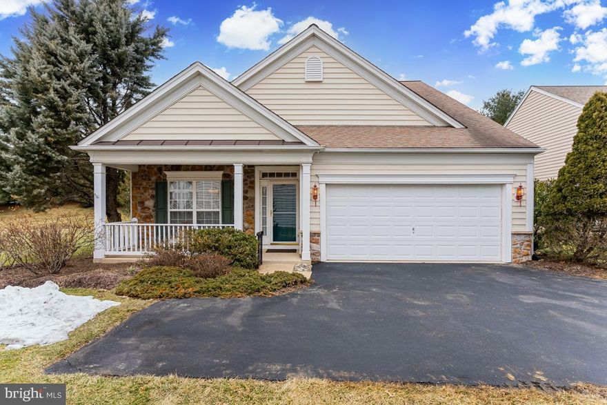 Sun-filled living spaces, soaring cathedral ceilings, and effortless first-floor living define this beautifully maintained Cape model in the highly sought-after 55+ community of Traditions at Longwood.
From the moment you enter, the home’s striking architectural design is immediately apparent. A welcoming foyer with hardwood flooring  opens to a dramatic living room featuring expansive cathedral windows and a stunning custom floor-to-ceiling hardwood fireplace mantel that creates a warm and inviting focal point.

The bright, spacious kitchen flows seamlessly into an impressive two-story living room highlighted by a natural gas fireplace and a wall of windows that fill the home with natural light. Just beyond, a charming sunroom offers the perfect space for a sitting area, den, or home office and provides direct access to a beautifully designed custom stone paver patio with decorative stone wall — ideal for relaxing or entertaining outdoors.

The private first-floor master suite is tucked quietly at the rear of the home and features a vaulted tray ceiling, a spacious walk-in closet, and a luxurious master bath with oversized custom tiled walk-in shower, linen closet, and a seamless long span vanity with twin sinks and  a sitting area offers an uncluttered, peaceful surface, making it the perfect foundation for a daily spa-inspired ambiance.   A second main-level bedroom and full hall bath with handicap-accessible tub/shower provide flexibility for guests or everyday living, while the conveniently located laundry room and interior access to the two-car garage add to the ease of first-floor living.

Upstairs, you’ll find a generously sized third bedroom, full bath, and expansive loft perfect for a guest retreat, second family room, or hobby space. A large, floored attic provides exceptional storage.
Throughout the home, you’ll appreciate elegant architectural details including hardwood and tile flooring, crown molding, custom millwork, panel box molding, arched openings, and detailed ceiling work. The home is also handicap-friendly with widened doorways, lower light switches, and thoughtful accessibility features.

Property Highlights
• 3 Bedrooms | 3 Full Baths
• Cape Model with Two-Car Attached Garage
• First-Floor Primary Suite
• Cathedral Ceilings & Expansive Windows
• Custom Floor-to-Ceiling Fireplace Mantel
• Two-Story Family Room with Gas Fireplace
• Sunroom with Patio Access
• Custom Paver Patio with Decorative Stone Wall
• Spacious Loft & Guest Suite
• Large Floored Attic Storage
• 2450+ square feet of finished living space
• Handicap-Friendly Design Features

Residents of Traditions at Longwood enjoy resort-style amenities including two clubhouses, a pool with pergola seating, tennis and bocce courts, billiards and card rooms, scenic walking paths, and a picturesque pond frequently visited by swans and egrets. Ideally located just minutes from Longwood Gardens and close to the shopping, dining, and culture of West Chester and Wilmington, this home offers the perfect blend of luxury, convenience, and lifestyle. Schedule your private tour today and experience everything this exceptional home has to offer!