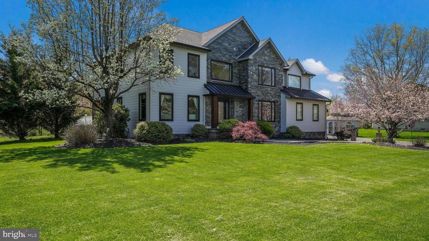 Welcome to a truly exceptional Home where no detail has been overlooked. From the moment you arrive, the stunning exterior makes a lasting impression—featuring a dramatic total transformation with Hardie board siding, stacked quarry stone, sleek metal roof sections, Azek-wrapped bump-outs and columns, and all-new trim. The Pella full picture casement windows tie the entire exterior together, introducing a modern twist elevating the overall design. Step inside the impressive two-story foyer, where a dramatic, custom-turned staircase—expertly crafted by a master carpenter—serves as a stunning centerpiece. Hand-scraped hardwood floors set a rich and inviting tone that flows throughout the main level. Just off the foyer, a dedicated home office offers a quiet space to focus or unwind. The formal living area opens to a gracious dining room, highlighted by crown moldings, large picture windows, and a  bump-out box bay window seat—perfect for intimate gatherings or quiet reflection. At the heart of the home lies a gourmet kitchen designed for both style and function. Vaulted ceilings in the breakfast room enhance the sense of space, while new warm birch cabinetry, granite countertops, under-cabinet lighting, and a custom tile backsplash add a luxurious touch. A tiered serving ledge and full island with seating make this an ideal spot for casual meals or entertaining. The kitchen opens to the family room, where a stacked stone gas fireplace serves as the focal point, while oversized windows on the adjacent wall showcase views of the lush, tree-lined backyard. A glass door opens to an expansive deck—ideal for hosting or simply enjoying nature in privacy. The first level also includes a powder room and a convenient laundry/mudroom with garage access. Descend into the stunning, fully finished lower level, where an expansive recreation area awaits. Featuring ceramic tile flooring with artistic inlays. Designed for entertaining this space includes a custom curved bar with built-in shelving, pendant lighting, wine storage, and a tiled arched center sink. Ample room for a pool table and play zones. A separate media room with recessed lighting, soundproof insulation, built-in TV, and beveled glass double doors offers a cinematic experience. A storage room with shelving adds practical organization. A stylish full bathroom with walk-in shower and sleek tile finishes completes the lower level. Upstairs, you'll find four generously sized bedrooms, with the primary suite offering a true private sanctuary, complete with its own sitting room. Accessed through double doors and secluded behind glass atrium doors, this sitting room is perfect for quiet moments or TV viewing. The main bedroom features vaulted ceilings and a unique corner double window, with cozy window seats on both sides providing a serene spot to relax and enjoy sweeping views of the backyard and nature. The spanning walk-in closet is thoughtfully designed with two entry doors, creating a seamless flow. Dedicated sections with built-in towers offer shelves and drawers for optimal organization. The luxurious en suite bath features double vanities, a spa-style shower, dual linen closets, and a raised platform soaking tub as its centerpiece. The hallway bath is updated with double sinks, sleek tile, and a modern glass-enclosed tub and shower. The bright and spacious secondary bedrooms are filled with natural light from large windows, creating a welcoming environment. Outdoor highlights include a beautifully landscaped backyard with flowering trees, ornamental grasses, pavered walkways, a wooded backdrop with park bench, a versatile storage shed, and just off the driveway, a hexagon pavilion with stone accents, electric, and plumbing—perfect for a workshop, hobby studio, or garden retreat. Full house generator. This home blends architectural elegance with thoughtful upgrades throughout, delivering luxury, comfort, and character —with even more waiting to be discovered…Wow!