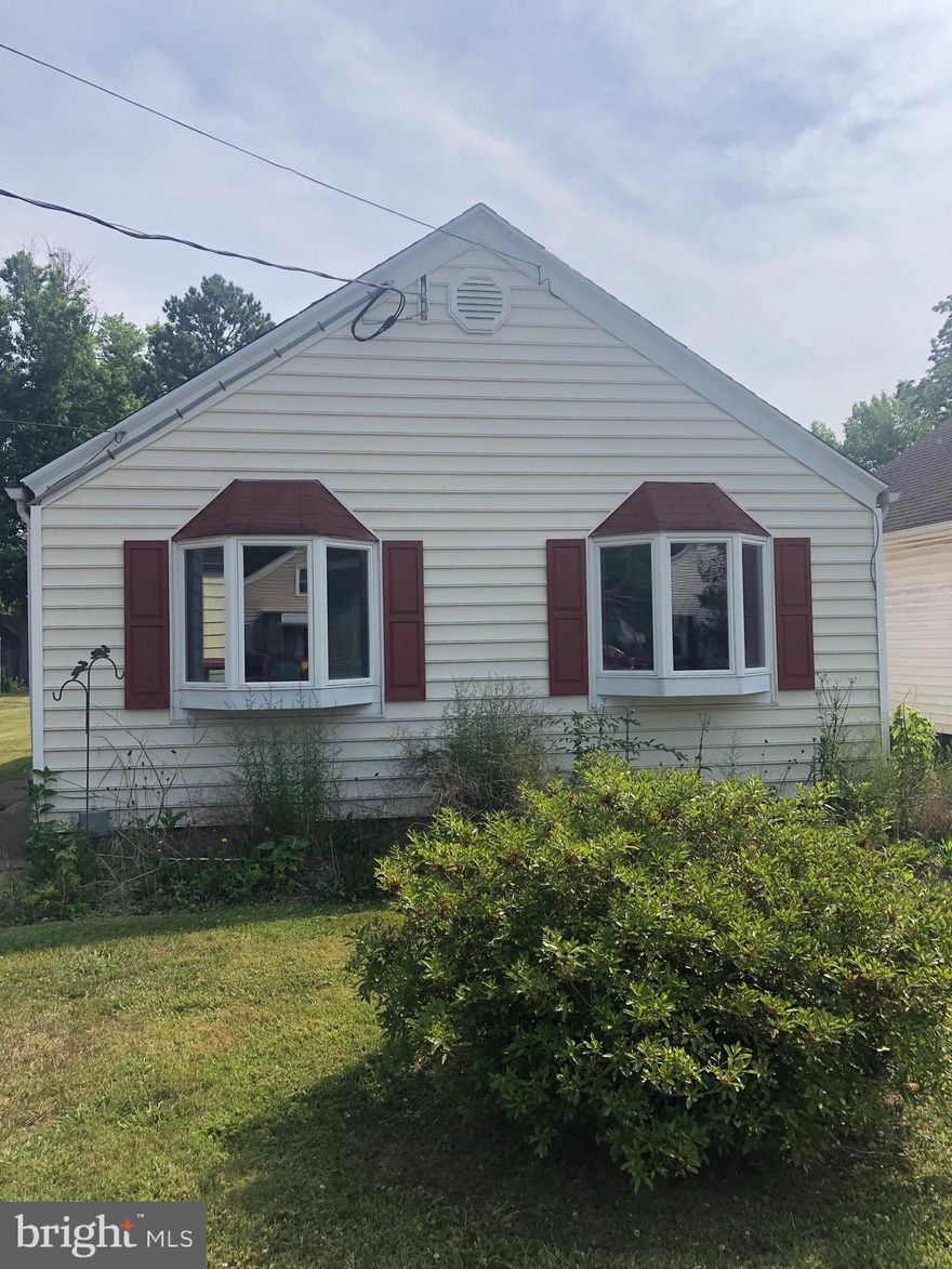Welcome to this well thought-out designed home in one of the quietest neighborhoods in Cambridge. Homes here don't come available very ofter. Within the city limits, this home offers a peaceful setting yet close to Great Marsh Park, local tennis courts, and  pickle ball courts, and just blocks away from downtown. This "AS IS" home is ready for a renovation that will highlight its lines and contours. Not only does this home have off-street parking, it has a huge two-car, rear-entry garage in the rear of the property. The numerous windows provide a bright interior the flows nicely from front to back. The built-in bookcases in the living room surround the one of two bay windows. Under the carpet there are hardwood floors. The stove, washer/dryer, and refrigerator all convey. This rare gem will not last long.