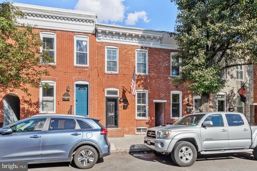 Welcome to 1429 Battery Avenue, a beautifully maintained 2-bedroom, 2.5-bath rowhome in the vibrant Federal Hill neighborhood. This home offers refined living with a practical layout, including a convenient parking pad and a stunning two-tiered rooftop deck. Enjoy a spacious open-plan living area leading to a gourmet kitchen with stainless steel appliances, granite countertops, and abundant cabinetry. The main level also features a mudroom/laundry and a half bath. Upstairs, find two generously sized bedrooms each with en-suite bathrooms and ample closet space. The highlight is the brand new rooftop deck, perfect for entertaining while taking in stunning city views. Situated just blocks from Cross Street Market, Riverside Park, and Federal Hill Park, with quick access to I-95.