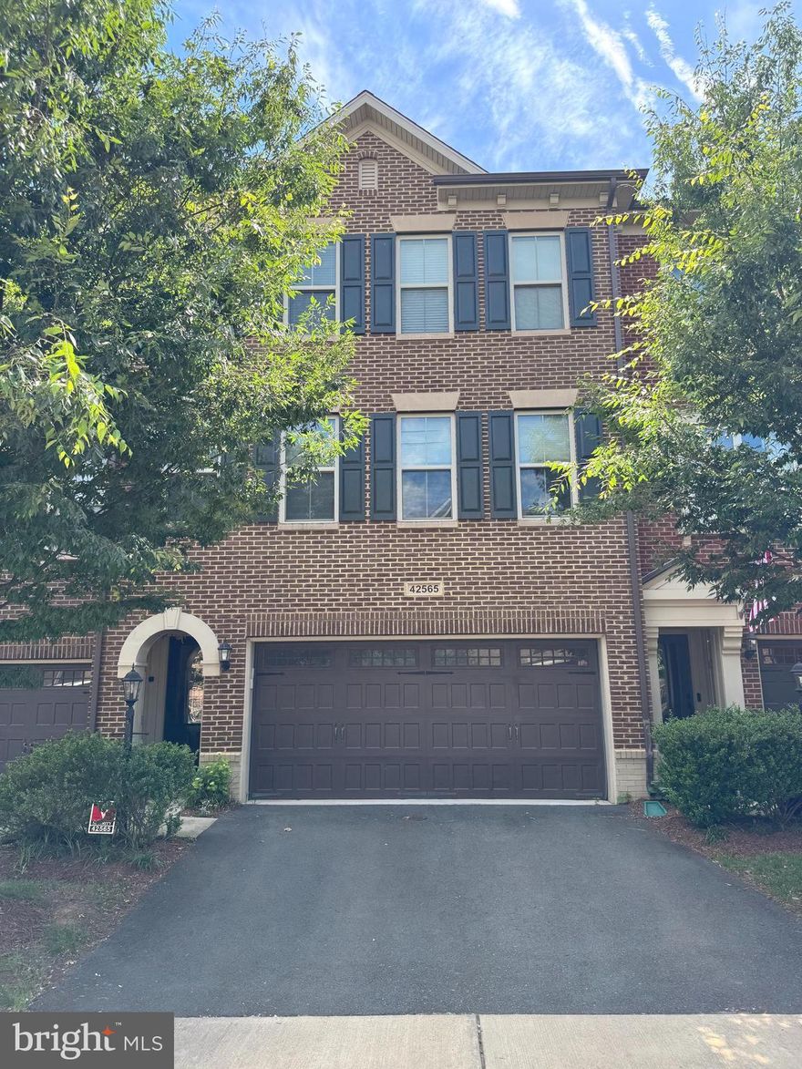 Luxurious 3-Level Townhome in the Heart of Brambleton – Best Value in Town!

Discover upscale living in this beautifully upgraded 3-story, 3,182 sq ft Tripointe Paxton model townhome, featuring a premium Northeast-facing elevation with elegant brick exterior. Located in the sought-after Brambleton community, this home offers a perfect blend of comfort, functionality, and luxury with 4 full bathrooms, 3 spacious bedrooms, a dedicated office or guest bedroom on the main level, and a fully finished walkout basement.

Step inside to a bright open-concept floor plan highlighted by brand-new wide plank luxury vinyl flooring throughout the lower and main levels. The gourmet kitchen boasts high-end cabinetry, granite countertops, stainless steel appliances, a spacious pantry, and an oversized island with bar seating—ideal for meal prep and entertaining. The adjacent living and dining rooms flow seamlessly into a wraparound Trex deck, perfect for hosting gatherings or enjoying a peaceful evening outdoors.

The main level also features a versatile room with a full bath, ideal for a home office or in-law suite. Upstairs, unwind in the luxurious primary suite, complete with tray ceiling, an expansive walk-in closet, and a spa-inspired bath with frameless Roman shower, soaking tub, double vanity sinks, and floor-to-ceiling ceramic tile finishes. Two additional bedrooms, a shared full bath, and a convenient upper-level laundry room round out the top floor.

The fully finished lower level includes a generous recreation room with an en-suite full bath, perfect for guests or a playroom. Step outside to a beautifully landscaped stone patio and fully fenced backyard overlooking a large open green space, ideal for kids, pets, and year-round enjoyment.

Additional features include a front-load 2-car garage with upgraded doors, extra storage racks, and an extended driveway. Verizon FIOS Internet and TV cable are included in the HOA, which also covers lawn care, snow removal, trash/recycling, and access to community amenities.

Enjoy Brambleton’s 18 miles of paved trails, tennis courts, sand volleyball, parks, and nearby kids’ play areas. Walk to Brambleton Town Center for dining, movies, coffee, groceries (Harris Teeter), healthcare, and gas. This home offers an excellent commuter location with easy access to the Metro bus stop, Dulles Greenway, and Toll Road.

Don't miss this exceptional opportunity to rent a premium luxury townhome in one of Northern Virginia’s most vibrant communities!