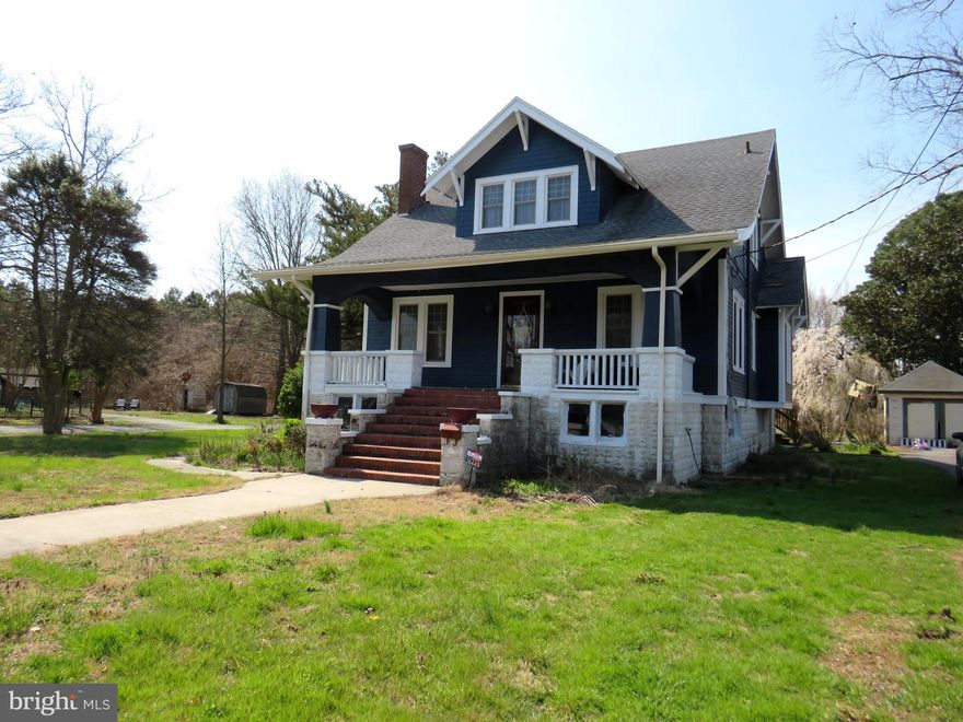 Well cared for Craftsman style home on large corner lot outside city limits.  Large open front porch opens to a gracious living room.  Center foyer/staircase leads to the dining/family room and eat in kitchen. Utilty area adjacent to kitchen, and there is a front room used as a bedroom but would make a great office as well.  There are two full baths on the first floor.  The second floor has a large open hall way  leading to three bedrooms.  There are beautiful hardwood floors, original oak trim and molding, and a small rear deck.  A full basement is great storage, and has a sump pump.  There is a frame garage/storage building and an asphalt driveway.  A comfortable home with all the amenities and a lot of the charm from the past.  Interior photos coming soon!