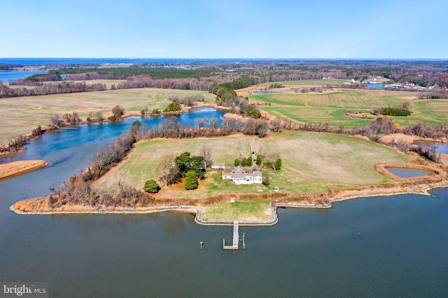 Discover the unparalleled beauty and serenity of Kelly’s Bank, an extraordinary 31.99-acre waterfront estate offered for the first time. Nestled along over 4,400 feet of shoreline on Langford Bay and a protected cove, this completely renovated home offers breathtaking water views from every room. Sitting high on a bank outside the flood zone, this meticulously updated residence features 5 bedrooms, 3.5 bathrooms, and timeless craftsmanship throughout. The primary suite is a luxurious retreat with a spacious en-suite bathroom, walk-in closet, sitting area, and gas fireplace. At the heart of the home is the chef’s kitchen, designed for entertaining, with an oversized island and walk-in pantry. The living and dining areas feature original hardwood floors, a wood-burning fireplace, and exquisite paneling, adding warmth and character. A sunroom with a wall of windows showcases panoramic views of Langford Bay and the Chester River.
The four guest bedrooms are thoughtfully connected by Jack and Jill bathrooms. A partially finished basement features a gas fireplace, wet bar, and rough-in plumbing for an additional half bath, offering endless possibilities. Ample storage and a whole-house generator ensure convenience and peace of mind.
Beyond the home, the property offers 16 tillable acres, a pond, a multi-slip dock, and abundant wildlife, making it a prime location for deer and waterfowl hunting. The detached two-car garage and shed/workshop provide additional space, with the potential to transform the workshop into a future poolside cabana. Kelly's Bank is conveniently located for boating to Rock Hall, Chestertown, Kent Island, and other points on the Bay. 
Don’t miss the opportunity to own this one-of-a-kind private waterfront retreat. Schedule your private tour today!