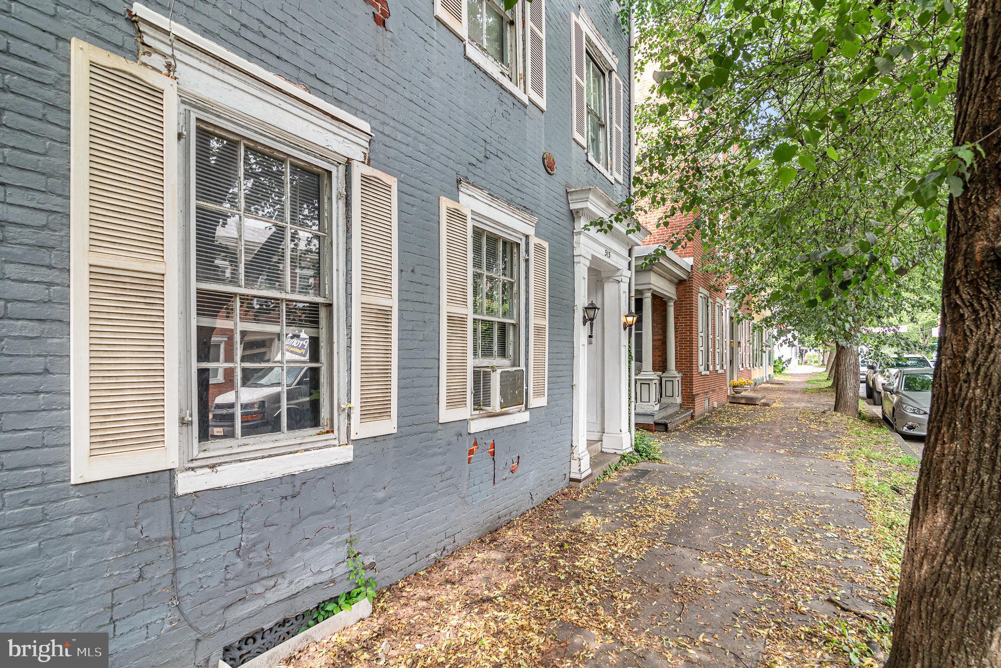 Enjoy living in historic Downtown Mechanicsburg in this brick colonial style home from the 1850's! This recently renovated 3-story home with 5 bedrooms and 2.5 bathrooms has been updated while restoring its original charm! Unique features include 9' ceilings on the first and second floor, a balcony off the second floor bedroom, wall to wall cherry colonial built-ins in the dining room, original transom window above dining room doors with the original hardware still intact, original french doors to the living room, beehive bake oven in the summer kitchen, raised hearth in the kitchen with installed gas fireplace, and smoke shack still intact at the back of the home. Updates include refinished floors, professional paint, modern lighting, and a new roof installed in 2016. This home also features a new vinyl fence in yard and off street parking. One section of the roof was recently replaced.