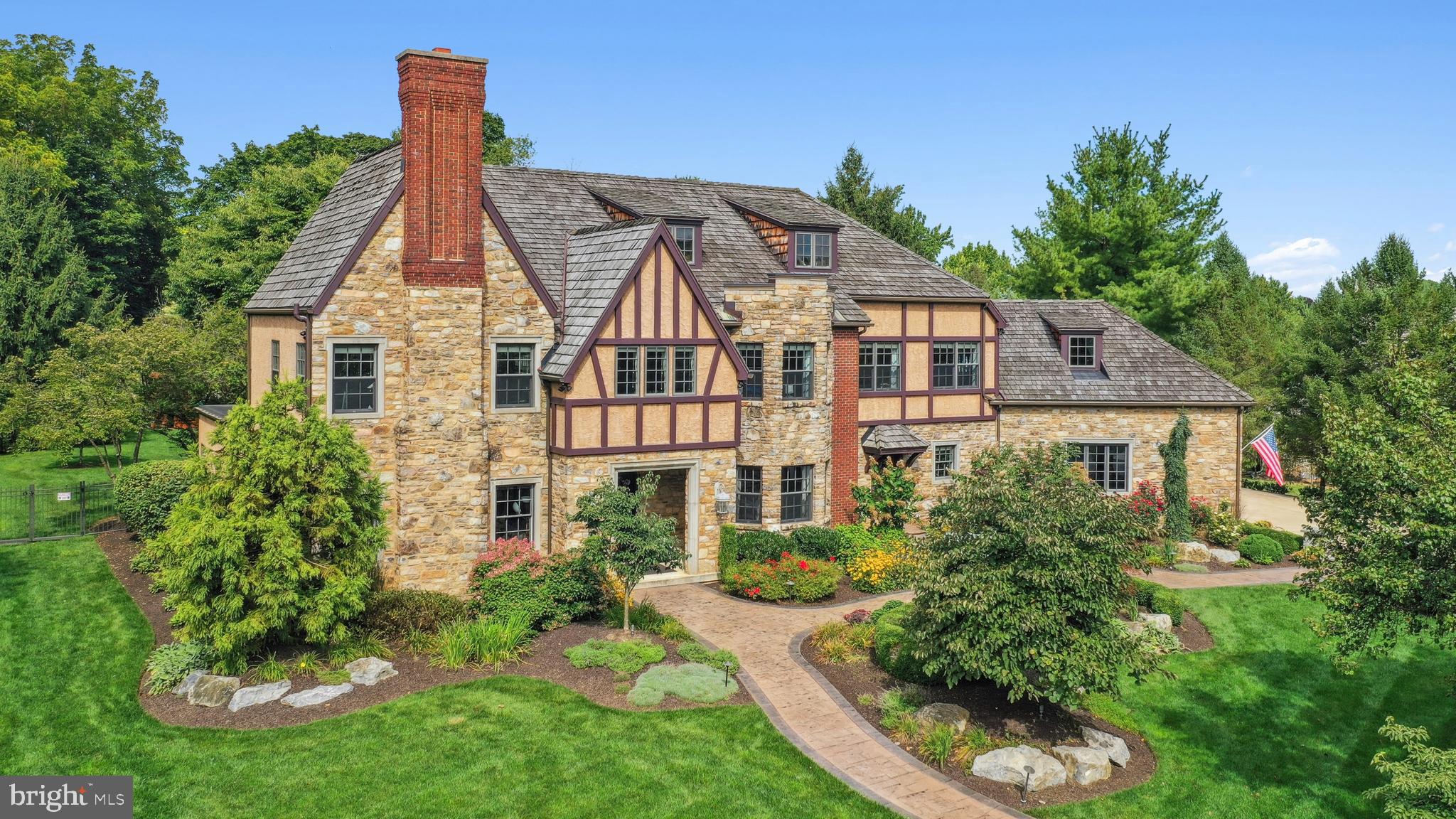 Best defined by sophistication and architectural interest at every turn, this captivating English Tudor reflects the beauty and prestige of its surroundings.
Built by Myron Haydt and prominently set on 1.1 ACRES in Westbury Park, the home impresses at first glance with a STONE AND BRICK FACADE, a CEDAR SHAKE ROOF and intriguing rooflines, all accented by a framework of exceptional plantings and established trees. STAMPED CONCRETE PATHWAYS, STONE PILLARS, raised plant beds and an irrigation system were all part of the recent landscaping. Redolent of the graceful splendor of grand homes one might find nestled in the European countryside, the style appears untouched by time.
With OVER ONE MILLION DOLLARS IN RENOVATIONS since purchase, there are stunning appointments such as 2023 WIDE PLANK RED OAK FLOOR, NINE FOOT CEILINGS, grand custom moldings, custom cabinetry and solid wood doors throughout. Welcoming first floor rooms are bathed in light through oversized windows, all generously sized for contemporary living and seamless entertaining. The first floor office has custom wood paneling and cabinetry, a COFFERED CEILING and a wood burning fireplace. A breathtaking renovation opened the family room to the DRAMATIC 2023 KITCHEN, breakfast room, prep kitchen and butler’s pantry, all beautifully appointed with top-of-the-line appliances and magazine quality, custom cabinetry. Multiple French doors open to the paver patio…a sanctuary on which to savor morning coffee and delight in visiting songbirds.
Front and back staircases access the second floor where the PRIMARY SUITE, WITH FIREPLACE, was FULLY RENOVATED IN 2023. A balcony overlooks the very private back yard. There is an enormous master closet, professionally designed with custom organizers and cabinetry. However, the piece-de-resistance is the primary bath, with radiant heat, soaking tub and dual entry glass shower. Designed for privacy and comfort, three ensuite bedrooms and a large MULTI-PURPOSE ROOM complete this floor.
These many new amenities were added to meet the needs of today’s families, with rooms for every need or hobby. The lower level family room opens, through a floor-to-ceiling glass wall, to a 2000 BOTTLE WINE CELLAR, with Wine Guardian cooling, designed and built by Joseph and Curtis in 2017.
A three-car oversized garage, and great commuter location add to the appeal of this extraordinary home minutes from Lehigh Valley Hospital, I-78 and the PA Turnpike. Access to The Lehigh Parkway, a 629 acre park along the Little Lehigh River, is at the end of the block. The Lehigh Parkway is just beautiful…with many walking and running paths and loops. A house to entertain in, to live in and to cherish, this classic property is every bit as noteworthy as its location.