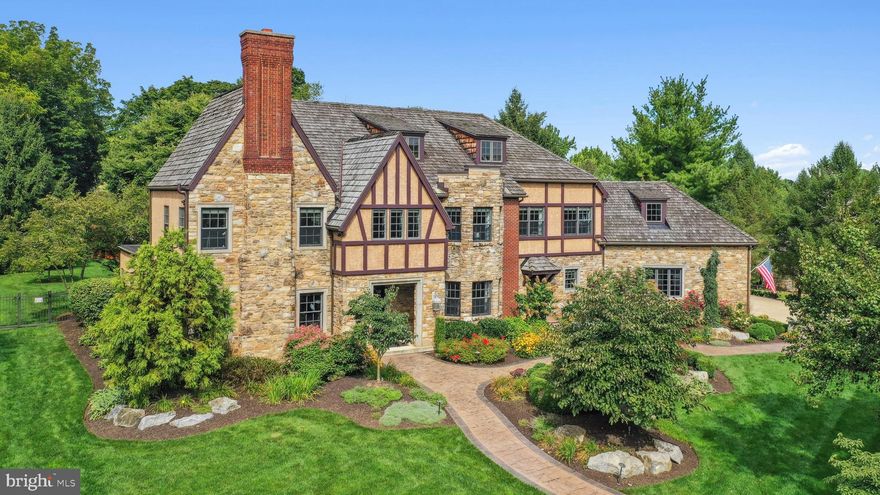 Best defined by sophistication and architectural interest at every turn, this captivating English Tudor reflects the beauty and prestige of its surroundings. 
     Built by Myron Haydt and prominently set on 1.1 ACRES in Westbury Park, the home impresses at first glance with a STONE AND BRICK FACADE, a CEDAR SHAKE ROOF and intriguing rooflines, all accented by a framework of exceptional plantings and established trees. STAMPED CONCRETE PATHWAYS, STONE PILLARS, raised plant beds and an irrigation system were all part of the recent landscaping. Redolent of the graceful splendor of grand homes one might find nestled in the European countryside, the style appears untouched by time.
     With OVER ONE MILLION DOLLARS IN RENOVATIONS since purchase, there are stunning appointments such as 2023 WIDE PLANK RED OAK FLOOR, NINE FOOT CEILINGS, grand custom moldings, custom cabinetry and solid wood doors throughout. Welcoming first floor rooms are bathed in light through oversized windows, all generously sized for contemporary living and seamless entertaining. The first floor office has custom wood paneling and cabinetry, a COFFERED CEILING and a wood burning fireplace. A breathtaking renovation opened the family room to the DRAMATIC 2023 KITCHEN, breakfast room, prep kitchen and butler’s pantry, all beautifully appointed with top-of-the-line appliances and magazine quality, custom cabinetry. Multiple French doors open to the paver patio…a sanctuary on which to savor morning coffee and delight in visiting songbirds.
     Front and back staircases access the second floor where the PRIMARY SUITE, WITH FIREPLACE, was FULLY RENOVATED IN 2023. A balcony overlooks the very private back yard. There is an enormous master closet, professionally designed with custom organizers and cabinetry. However, the piece-de-resistance is the primary bath, with radiant heat, soaking tub and dual entry glass shower. Designed for privacy and comfort, three ensuite bedrooms and a large MULTI-PURPOSE ROOM complete this floor.
     These many new amenities were added to meet the needs of today’s families, with rooms for every need or hobby. The lower level family room opens, through a floor-to-ceiling glass wall, to a 2000 BOTTLE WINE CELLAR, with Wine Guardian cooling, designed and built by Joseph and Curtis in 2017.
     A three-car oversized garage, and great commuter location add to the appeal of this extraordinary home minutes from Lehigh Valley Hospital, I-78 and the PA Turnpike. Access to The Lehigh Parkway, a 629 acre park along the Little Lehigh River, is at the end of the block.  The Lehigh Parkway is just beautiful…with many walking and running paths and loops. A house to entertain in, to live in and to cherish, this classic property is every bit as noteworthy as its location.