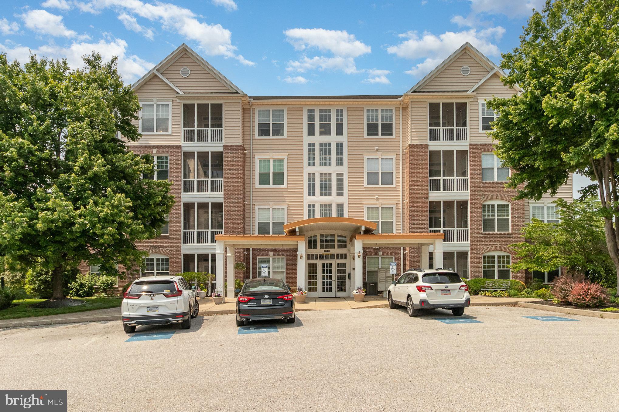 SPECTACULAR meticulously kept move-in ready condo with elevator access in the 55+ community of Regents Glen. Enjoy carefree living in this 2 bedroom, 2 full bath condo on the top (4th) floor. This home is specifically designed for those who crave a spacious open floor living experience. You’ll feel welcome once you walk down the hall and open the front door for the first time. You will notice the 9 foot ceilings, hardwood floors and the abundance of natural light. The eat-in-kitchen with island is the focal point of the condo with all other rooms around it. The kitchen has plenty of cabinets and countertops to do your day to day cooking and the appliances convey, dining area and recessed lights. Off the kitchen is the family room/sitting area with gas fireplace. The primary bedroom suite is generous in size carpet, a walk-in closet, primary bathroom with ceramic tile flooring, and step in shower. The guest bedroom down the hall is also carpeted and a nice size with the laundry room and 2nd bathroom adjacent with ceramic tile flooring and a tub/shower combination. Once leaving the hall area are the dining room and living room with sliders to the screened, private balcony where you can relax and enjoy the views as you drink your morning coffee or just relax and read a book. Other features include forced air gas heating, central air, and a few ceiling fans. Regents Glen community offers many amenities including a golf course, driving range, swimming pool, fitness center and dining. Located within walking distance to York County Rail Trail and easy access to I83. Don’t miss out in seeing this terrific home.
