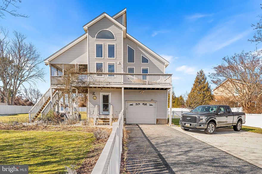Coastal Charmer in South Point with views overlooking Sinepuxent Bay! This home is for the Outdoor Enthusiasts that enjoys watching Eastern Shore Wildlife & Sunrises! There are many windows & porches throughout to enjoy the Breathtaking scenery! Huge Privately Fenced, .59 Acre yard with firepit, gardens, private patio with tv hookup, outdoor shower and oversized shed with water and electric! The spacious, 2 story- living area features a cozy gas fireplace, ideal for gathering on cool evenings. The galley kitchen is located next to the High Ceiling & Elegant Dining area, with access to Al Fresco dining in your Screened in porch. The porch has accessible stairs  down to the patio with Charcoal BBQ grill.  The home boasts three bedrooms, including an Entry Level Bedroom / Studio with  private entrance.  There is a Main Level Ensuite, while the Upper level Loft features a Library  and Office overlooking the Bay!  This connects to the Cozy En-suite Bedroom with private bathroom. Ceiling fans throughout enhance airflow, ensuring a pleasant ambiance year-round. Step outside to experience the outdoor oasis that awaits. The exterior features a screened porch and multiple outdoor porches & spaces, perfect for savoring morning coffee or hosting summer barbecues. The Expansive & Level yard awaits your every Gardeners' dream.  The outside shower adds a refreshing touch after a day spent by the nearby Sinepuxent Bay, just a short stroll away. The property also includes convenient boat storage, catering to those who enjoy water activities. Set on a generous 0.59-acre lot, the home offers ample parking with a front-entry garage and a spacious Concrete Parking Pad for 3 cars and paved driveway, accommodating guests with ease. The beautifully landscaped surroundings provide a sense of privacy and tranquility, making it an ideal retreat from the hustle and bustle of everyday life. This property is not just a home; it's a lifestyle. With its proximity to the bay, you can indulge in leisurely walks along the water, enjoy boating adventures, or simply bask in the beauty of nature. Experience the perfect blend of luxury and comfort in this stunning community of South Point.  Close to many attractions such as Rum Pointe and Ocean City Golf courses, yet a close drive or boat ride to Downtown Ocean City and Assateague State Park!  Don't miss this once in a lifetime opportunity!