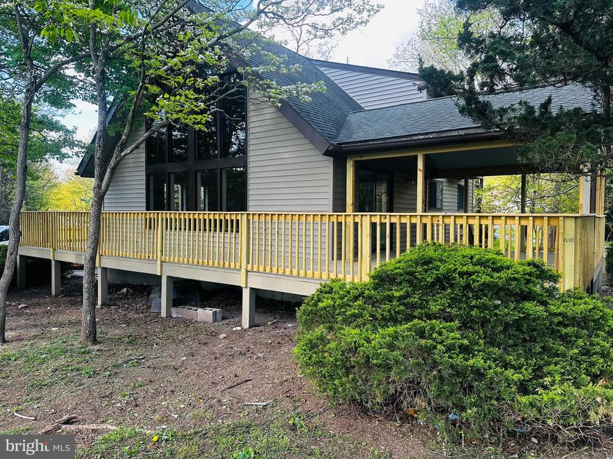 Nestled in The Woods community, this charming A-Frame home offers three bedrooms, two baths, and stunning views of the adjacent golf course. Vaulted ceilings and an open layout create a warm and inviting atmosphere, perfect for gatherings. Enjoy modern amenities in the kitchen and relax on the spacious deck overlooking the fairways. Retreat to the serene bedrooms, including a master suite with a private bath. With access to community amenities like golfing and hiking, this home provides a perfect mountain getaway. Experience tranquility and beauty in The Woods—schedule your tour today!