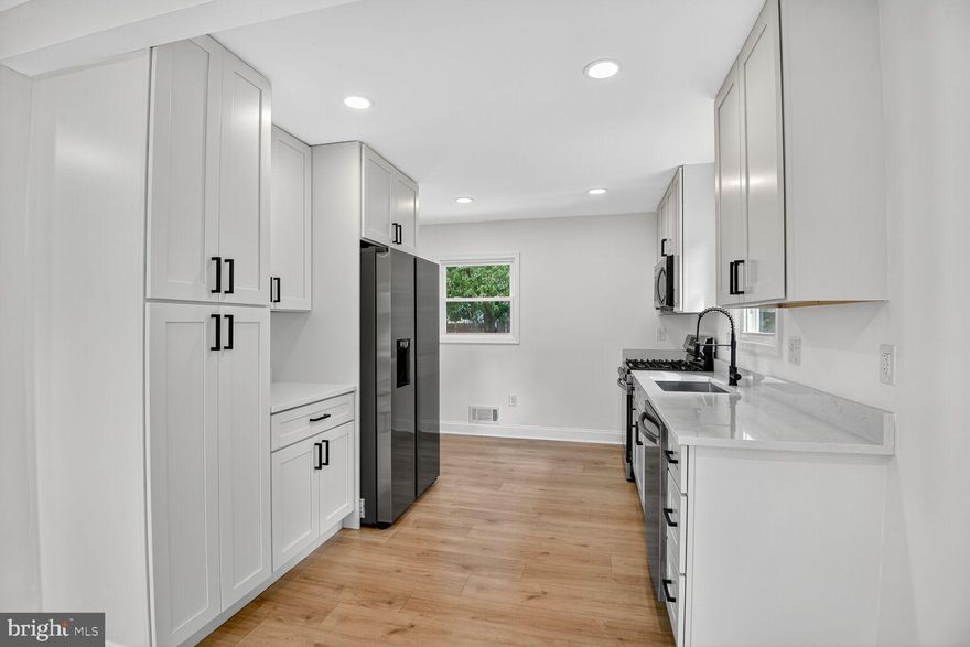 Welcome to your newly renovated gorgeous home!! This stunning home offers 4 bedrooms and 2 full bathrooms, with beautiful engineered hardwood flooring throughout. The spacious main kitchen features stainless steel appliances, quartz countertops, shaker cabinets, a built-in microwave, and plenty of room for culinary creations. The fully finished basement includes its own bedroom, full bathroom and full kitchen,  making it ideal for guests or extended family. For added convenience, each level is equipped with its own washer and dryer units. Recent upgrades include, upgraded electrical system, and entirely new plumbing, new flooring, and new windows, and new drywalls, new HVAC system,  and new insulation throughout the house—offering both elegance and peace of mind. Conveniently located near shopping centers with easy access to I-495, this home is move-in ready and waiting for you to enjoy!