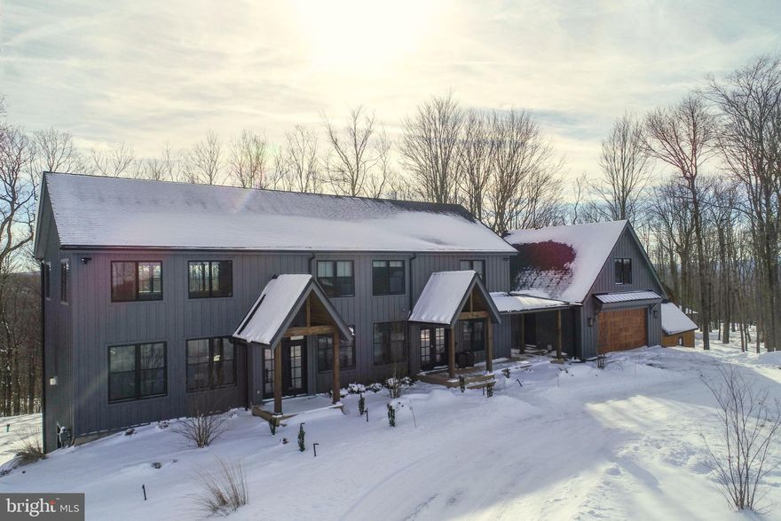 “Endless Journey” delivers mountain living with a bold punch. A proven rental clearing over $100k in 2024—this six-bedroom, six-full, two-half-bath retreat sits in a quiet wooded pocket with wide southwest views rolling across the trees. A huge open living area runs bright and modern, with clean lines, warm finishes, and a sharp stone fireplace. Shiny kitchen with stone tops, custom cabinetry, stainless appliances, and an island bar. En-suite baths offer tiled showers and heated floors. Spacious layout opening to multiple outdoor spaces made for slow mornings and long nights. The deck pulls in the sunset, while the hot tub and fire pit round out the mountain vibes. Loads of additional living space! Lower level complete with a game room and wet bar. Two-car garage with a bonus hangout upstairs. Ski nook that keeps boots, boards, and gear organized. Durable luxury vinyl flooring, Trex-style decking, public water and sewer, and a whole-house generator keep the home low-maintenance and ready for every season. The setting puts you minutes from skiing, snowboarding, local marinas, and every local spot along 219. A strong rental, private escape, and a turnkey launchpad into the Deep Creek lifestyle. Call today to schedule your private showing!