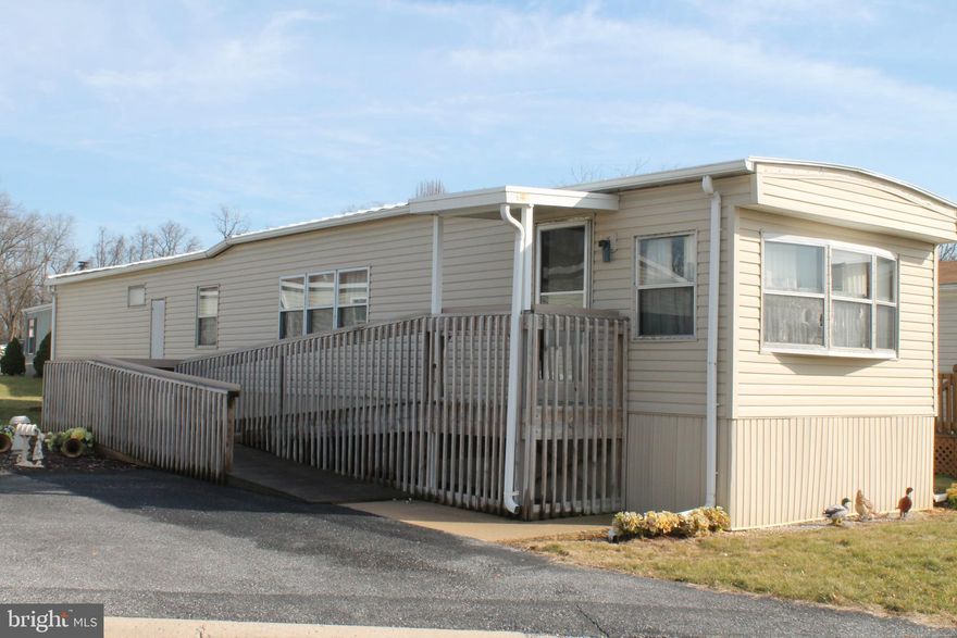 1972 New Moon with vinyl siding and steel roof x  Handicapped ramp, 2 car driveway x kitchen with breakfast bar, dining room, bright open living room.  2 bedrooms and bath x Newer furnace, AC, and water heater, electric panel updated in 2012 and new hat tape in 2014 x Seller has  maintains yearly contract with Electric and HVAC x contact agent for park information.   THE LOT RENT IN THE PARK IS $337 PER MONTH includes trash and sewer.