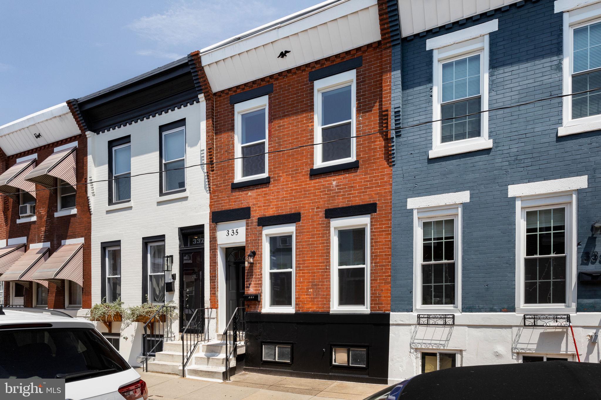 Located on a quiet, well-kept block in the sought-after Whitman section of South Philadelphia, 335 Daly St. is the ideal mix of modern upgrades and classic curb appeal. This fully renovated 3-bedroom, 1.5-bath home offers thoughtful design details, and unbeatable walkability to major shopping. The exterior features timeless red brick with freshly painted black trim, and brand new windows throughout give it a clean, contemporary look. Inside, wide plank oak-toned flooring runs throughout, complimented by sleek black hardware on all doors for a cohesive and stylish feel. The spacious kitchen is a true highlight, featuring quartz countertops, gold cabinet hardware, a gold faucet, and an abundance of cabinetry including a full-sized pantry, perfect for those who love to cook or entertain. A convenient powder room on the first floor adds functionality, and the large private patio out back offers the ideal setup for summer barbecues, lounging, or container gardening. Upstairs, you’ll find three bedrooms & a beautifully designed full bathroom with marble tile flooring, and a built-in shower nook and shelf, making bath time both practical and luxurious. Snyder Plaza is just minutes away with Target, Acme, and more. You'll also have easy access to I-95, public transit, and the sports complexes, making commuting or weekend plans simple. This home checks every box for buyers looking for a turnkey property in a growing, connected neighborhood.