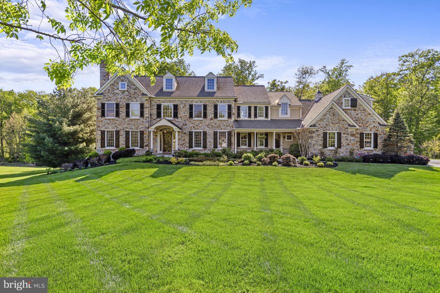 Set on a premier one-acre homesite in the coveted community of Applecross, this extraordinary custom-built colonial home offers 9,725 square feet of impeccably designed living space with 5 bedrooms, 6 full bathrooms, and 2 half baths. Masterfully blending timeless architectural elegance with today’s finest luxury amenities, the stately stone and Hardie Plank residence spans three magnificent levels surrounded by breathtaking views of manicured lawns and private woodlands. A dramatic entrance hall with a sweeping curved staircase introduces interiors defined by sophisticated craftsmanship, including random-width hand-hewn maple flooring, extensive custom millwork, oversized crown molding, wainscoting, soaring 10-foot ceilings, and expansive windows that flood the home with natural light. Gracious formal living and dining rooms are complemented by a handsome library with a stone fireplace, while the heart of the home unfolds into an exceptional great room featuring a coffered-ceiling family room with a natural stone fireplace and an unmatched chef’s kitchen. Designed for both everyday living and elegant entertaining, the kitchen is appointed with a substantial center island, top-tier appliances, butler’s pantry, breakfast room, and seamless access to the stunning four-season sunroom overlooking the rear grounds. The luxurious owner’s suite is a private retreat of exceptional scale and comfort, featuring a fireside sitting room, an enviable custom dressing room, and a spa-inspired marble bath with exquisite finishes and a soaking tub. Four additional spacious bedrooms each offer private en-suite baths and generous closets, providing comfort and privacy for family and guests alike. The beautifully finished walk-out lower level is designed for entertaining on a grand scale, complete with a custom full bar, expansive game and recreation spaces, family room area, full bath, and abundant storage. Outdoor living is equally impressive, highlighted by an expansive composite Epoch deck spanning nearly the length of the home, complete with a built-in Viking grill and wood-burning outdoor fireplace—creating the perfect setting for year-round entertaining against a backdrop of serene natural beauty. Additional amenities include a four-car garage, Lutron lighting system, integrated security and sound systems with in-ceiling speakers, air purification system, irrigation system, and elevator access to all three levels. Thoughtfully designed with seamless wheelchair accessibility, the home features stairless entries, wider doorways, and a roll-in shower, combining luxury with exceptional functionality. A truly pristine and remarkable Greenville estate offering unparalleled craftsmanship, sophistication, and comfort in one of the Brandywine Valley’s most desirable communities.