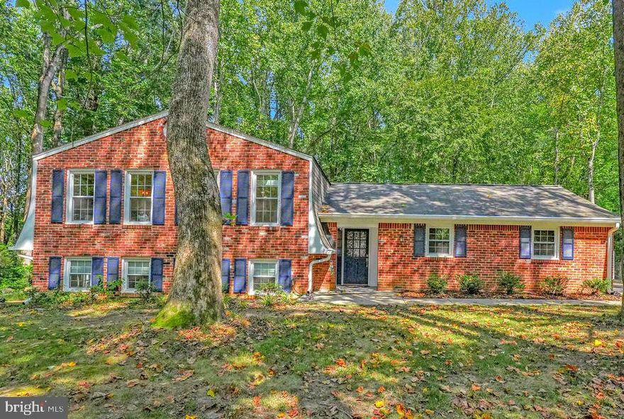 Rare opportunity to assume the seller’s current 4.50% VA loan, subject to lender approval and verification of the buyer’s VA entitlement eligibility, offering potential savings in today’s rate environment. This updated four-bedroom split-level home sits on a private 3.5-acre wooded lot at the end of a quiet cul-de-sac with no HOA, providing both privacy and flexibility in a sought-after Southern Maryland location near Waldorf, Hughesville, and La Plata. The bright and open interior blends classic split-level design with modern upgrades, featuring an updated kitchen with newer appliances, luxury vinyl plank flooring, fresh neutral paint, and abundant natural light throughout. The spacious primary suite includes a renovated en suite bath, while the secondary bathrooms have also been refreshed. The finished lower level offers additional living space with walk-out access to a fenced dog run, making it ideal for flexible use. Major system improvements include a 2023 conversion from oil to electric, a Carrier HVAC system with humidifier and in-light air filtration, and a water heater with filtration system. Outdoor features include a large fenced yard, patio, gazebo, and a peaceful stream just beyond the fence line, creating a private retreat setting. A two-car side-entry garage with EV charger and additional storage completes the package. This property is ideal for buyers searching for a split-level home with acreage, a no HOA property in Southern Maryland, or a VA assumable loan opportunity with commuter access to key routes.