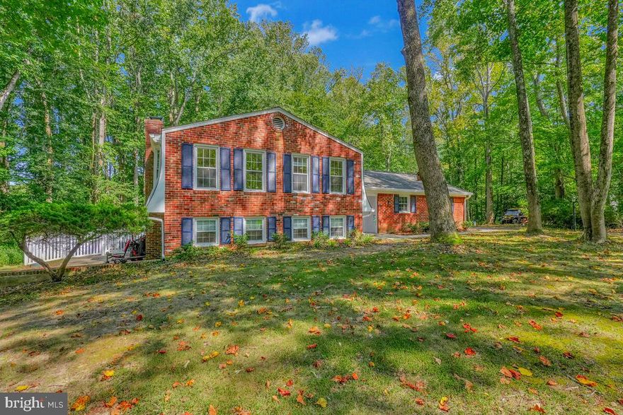 Assumable VA Loan Opportunity: Seller’s current VA loan at 4.50% may be assumed by a qualified buyer, subject to lender approval and verification of the buyer’s VA entitlement eligibility. This four-bedroom split-level offers a bright, open, and airy interior on a private 3.5-acre setting with no HOA. The home sits at the end of a quiet cul-de-sac and blends modern updates with classic split-level charm, giving you flexible living spaces, generous natural light, and room to spread out. Updates include an upgraded kitchen with newer appliances; LVP flooring and neutral paint; a spacious primary suite with updated en suite bath; refreshed secondary baths; and a lower level with direct access to a fenced dog run. Major systems upgraded with a 2023 conversion from oil to electric, featuring a Carrier HVAC system with humidifier and in-light filter, plus a water heater with filtration. Exterior highlights include a large fenced yard, patio, gazebo, and a peaceful stream just beyond the fence line. Two-car side-entry garage with EV charger and extra storage. A quiet, private setting yet close to Waldorf, Hughesville, La Plata, and key commuter routes across Southern Maryland.