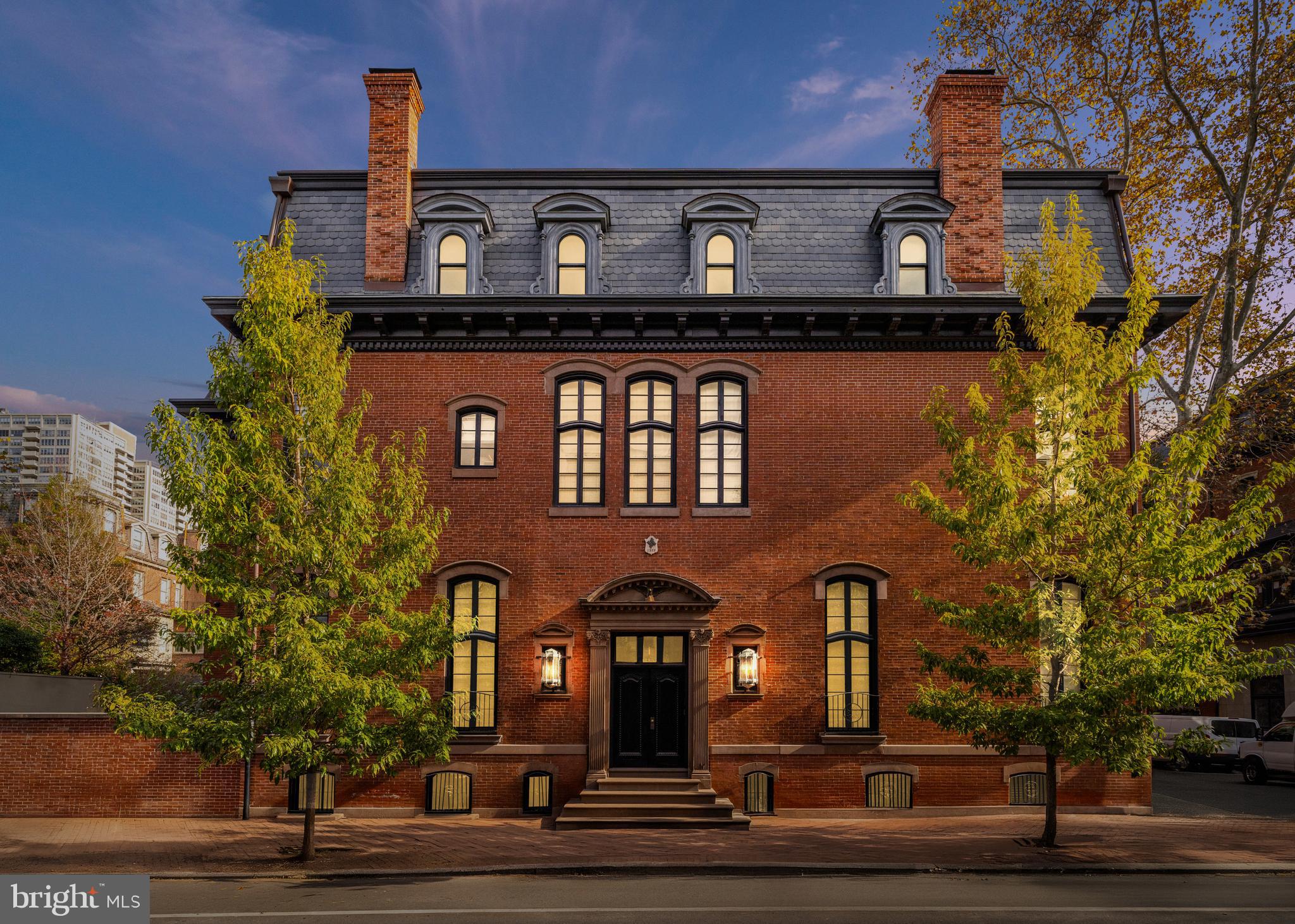 Old-world grandeur and modern European inspired luxury await in this meticulously renovated historic corner rowhouse featuring magazine-worthy designer interiors, an elevator and private outdoor space/parking on the most coveted block in Philadelphia, just inches from Rittenhouse and Fitler Squares.
Featured on the Philadelphia Register of Historic Places, this 1863 residence received a painstakingly thorough restoration from a collaboration between Philadelphia based STUDIO EDO and S.R. Gambrel from New York, that shows utter reverence for the home’s historic origins while adding bespoke upscale finishes and contemporary conveniences. Inside the 7,500-square-foot showplace, you’ll find an ideal layout for comfortable living and lavish entertaining alike. Ceilings soar up to almost 14 feet tall over exquisite millwork, custom finishes, hardwood and stone flooring, and oversized windows on three exposures, delivering unprecedented natural light throughout.
The 5 feet raised first floor, gives the lightwells a traditional window height. The lower ground level (cellar level), with ten feet ceilings, rough coat plaster walls and Belgian black heated stone floors making an inviting spot for everyday and casual gatherings. From the family room the view of the exceptional and spacious gourmet kitchen impresses with swaths of rich stone and custom lit cabinetry in limed oak. The state-of-the-art appliances include a vented La Cornue double oven range with a pot filler, two Sub-Zero refrigerators with freezers, two dishwashers and an ice maker. The massive center island adds a prep sink, seating and more storage, flanked by an open pantry with more counter space, a row of triple drawers and open lit shelving. A vitrine style butler’s pantry brings even more room for display and storage along with an independent coffee station and two large-capacity wine refrigerators. A powder room, mudroom and outdoor access with a spacious storage bunker and a wood, charcoal and gas barbecue designed and built in Argentina complete the lower level.
The home’s second level is dedicated to the tranquil owner’s retreat, featuring a sprawling king-size 13.5 feet high bedroom suite, with linen covered wall panels perfect for sound proofing, incorporated television. motorized blackout drapery, double exposures and a marble wood burning/gas fireplace. The Savile Row inspired limed oak dressing room with bespoke wooden hangers creates a handsome walk-in closet that attends to all wardrobe needs. The en suite spa bathroom boasts a double vanity, private water closet and rain-steam shower, all trimmed with fine stone and stained silver oak. A regal library offers floor-to-ceiling hand-lacquered paneling, inked glass panel insets and retrofitted bookcases and a hidden television. A concealed home office provides a private space for work with a gorgeous view of the surrounding homes and the Philadelphia skyline. The wood burning/gas fireplace framed in antique bronze and malachite panels as well as the cozy designer details invites you to curl up to enjoy your favorite novel or movie. The landing of the top floor is crowned by a Mayfair, London style skylight to flood the space with natural light and wash the Venetian plaster finished walls.
On the skylit top floor, two secondary suits and a large den, also ensuite, all include glamourous designer finishes and ensuite spa bathrooms, while rows of additional closets and a laundry room add convenience. Outside, a stunning brick façade with stone details, a mansard roof and dormer windows deliver curb appeal while the fenced courtyard is perfect for al fresco entertaining or off-street parking for one vehicle. From this outstanding Rittenhouse location, you're surrounded by the neighborhood’s centerpiece park and renowned local dining, with Philadelphia's best historic site, museums and amenities all within easy reach.