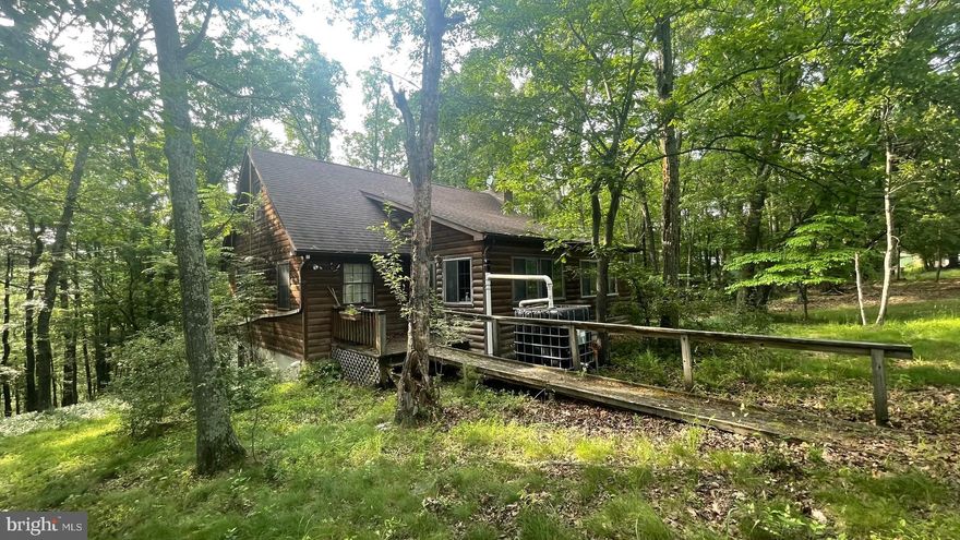 CALL NOW TO SEE THIS PRICED TO SELL CABIN  NEEDING TLC NESTLED IN THE WOODS.  THERE ARE 2 BEDROOMS AND A FULL BATHROOM ON THE MAIN FLOOR, LIVING ROOM, DINING AREA AND KITCHEN , ENCLOSED PORCH.  CONTINUE DOWNSTAIRS TO AN UNFINISHED BASEMENT WITH A FULL BATHROOM, ELECTRIC AND LOTS OF SPACE FOR STORAGE.  BACK UPSTAIRS IN THE LOFT AREA IS ANOTHER LARGE SPACE TO MAKE WHATEVER ROOM YOU WANT  IT TO BE.  BEST OF ALL THIS IS ALL ON 9 WOODED AND ROLLING ACRES. ENJOY THE WILDLIFE IN YOUR BACK YARD WHICH INCLUDES DEER, TURKEY, SQUIRRELS, BIRDS AND ASSORTMENT OF WHATEVER MAY COME TO VISIT. MOVE TO WEST VIRGINIA AND BECOME A MOUNTAINEER.