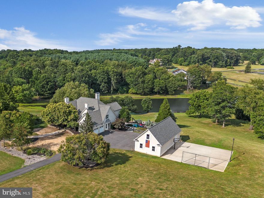 Welcome to this stunning Virginia Countryside Retreat with a Lake and Pool all part of this 15-acre estate. Escape to a picturesque country oasis where every day feels like a vacation. This stunning family home combines serene natural beauty with exquisite amenities, offering a lifestyle that's truly unmatched.
The heart of this home is a masterfully designed main level featuring a luxurious master suite complete with a spa-like bathroom and fabulous walk-in closet. The gourmet kitchen seamlessly blends with the family room, centered around a fireplace and adorned with Viking appliances, setting the stage for culinary delights and cherished family moments. The main and upper levels feature hardwood floors.  2-story living area room with floor to ceiling stone fireplace overlooking amazing lake and pool view. The internet via Comcast will keep you working from the home office with fireplace and custom wood-built ins. 
The upper-level features 4 large bedrooms each with ensuite bathrooms.
The lower walkout level boasts many windows and exit doors to the outside. Full size rec room and a sports bar with another inviting stone fireplace, creating the ultimate space for relaxation and entertainment. Stay active and healthy in the gym, while the separate playroom offers endless fun for kids of all ages. A thoughtfully designed au pair suite ensures privacy and comfort for extended family or guests. With six bedrooms, six full baths, and one-half baths, this home provides generous accommodations for all.
Step outdoors and be captivated by the expansive outdoor living spaces. A custom deck overlooks a very private pool with a terrace and outdoor firepit offering the perfect spot for sun-soaked days and tranquil evenings. The property also boasts a private lake, ideal for boating and fishing, surrounded by the beauty of the Middleburg Hunt countryside. This ultimate property also has attached 2-car garage and heated and cooled detached 4 car garage with staircase to finished space above. Your activities include professional basketball goal with court lightning. Pickleball awaits along with other sports.
Situated on over 15 rolling acres, this property offers a true sense of escape while still being conveniently close to Middleburg and Purcellville. All of this is accessible via paved roads and paved private driveway, ensuring both tranquility and ease of access.
With over 7600 sq. ft. of finished space across three levels, this home is a masterpiece of design and craftsmanship and further enhance the allure of this exquisite estate. Don't miss the opportunity to make this exceptional property your own. Schedule a private tour today and experience the epitome of luxurious country living.