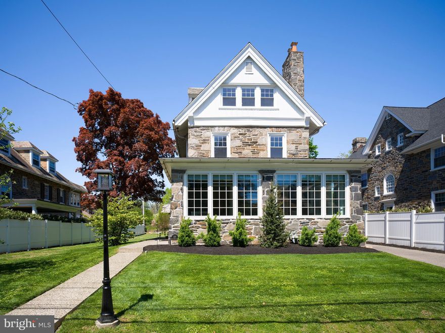 Built in 1910 and meaningfully updated across the past decade, 319 North Bowman is a stone Colonial whose next chapter is about to begin. Set back from a quiet, tree-lined street on a level quarter-acre, the house has the graceful proportions and abundant natural light that defined an era of Main Line architecture and craftsmanship - and that almost no one builds today. The current owners describe the experience of walking into the foyer as the moment that, after fifteen years, still simply feels good. That is the right place to begin, because it is the experience the next owner will inherit. The family room, re-glazed in 2024 with custom Marvin windows, fills with light early and is where the family gathers for coffee. The kitchen, deliberately separated from the dining room so the work of cooking stays out of view, is finished in cherry cabinetry and granite, with a five-burner gas cooktop, new double wall oven and dishwasher (2025), and a layout generous enough for a desk alongside the family table. Beyond the kitchen, the level rear yard opens up: flat, private, framed by mature plantings refreshed with new landscape and walkway in 2023. The home has carried both ends of the entertaining spectrum - dinner parties in the bay-windowed dining room in winter, large summer barbecues across the flat rear lawn, game nights in the living room, quiet glasses of wine in front of the fireplace. The lower-level storeroom holds the supplies for any of it, and the guest room has rescued more than one short-notice visit. The primary suite, with its sitting area, has been a place to retreat at the end of a long week. The third floor - three additional bedrooms and a full bath - gave the children room to spread out and grow into. The fully finished lower level, rebuilt in 2024 with French drain, Drylock waterproofing, and sump pumps, now functions as gym, craft studio, and homework hideout. A great deal of the work that has gone into this house is invisible: the lower-level waterproofing, the new windows in the family room, the fixtures and fittings refreshed across every bathroom in 2025, the radiators sanded and repainted, the lighting replaced throughout, the custom window treatments. None of it announces itself, and all of it is the reason the house feels effortlessly current despite being 116 years old. Merion Station is a walking neighborhood in a way that few Main Line addresses still are. Merion Elementary is a short walk. The Merion SEPTA station puts Center City within twenty minutes. Narberth - its restaurants, its shops, its Dickens Festival in December - is a stroll. So is the Barnes Foundation Arboretum and the wooded grounds of Saint Joseph’s University. Lower Merion School District serves the home: Merion Elementary, Bala Cynwyd Middle, Lower Merion High. Christmas lights along the eaves each December. French doors thrown open in spring. A foyer that, after fifteen years, still feels like coming home. The next chapter belongs to a family who will fill it the same way - room to spread out, room to grow, room to gather, in a community where the walk matters as much as the address.​​​​​​​​​​​​​​​​