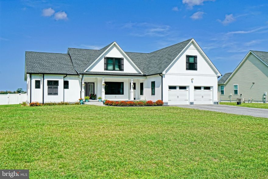 Custom-built and beautifully appointed, this home in the desirable Pintail Pointe community sits on nearly half an acre on the west side of Route 1 just 7.5 miles from downtown Lewes and the beach! With over 3,000 square feet of living space, this 4-bedroom, 3-bath residence offers a thoughtfully designed open split-floor plan ideal for both everyday living and entertaining. Inside, you’ll find luxury vinyl plank flooring and 9-foot ceilings throughout the main living areas, creating a bright and spacious atmosphere. The well-equipped kitchen features quartz countertops, a large island with seating, stainless steel appliances, a range hood, and a generous pantry. It opens seamlessly to the dining area and a cathedral-ceiling great room, enhancing the home’s open-concept appeal.  The primary suite serves as a private retreat with a walk-in tiled shower, double vanities, two large walk-in closets, and French doors leading to a full-length rear porch and patio. Step outside to a fenced backyard with white vinyl privacy fencing perfect for pets, kids play area, or just relaxing outdoors.  Additional features include a welcoming front porch, a dedicated laundry room with utility sink off the 2-car garage, and two additional first-floor bedrooms with a full bath. A spacious bonus room above the garage provides a fourth bedroom and third full bath, ideal for guests or a home office. Located in the highly regarded Cape Henlopen School District and just minutes from shopping, dining, beaches, and bike trails, this home offers the perfect blend of comfort, quality, and convenience.