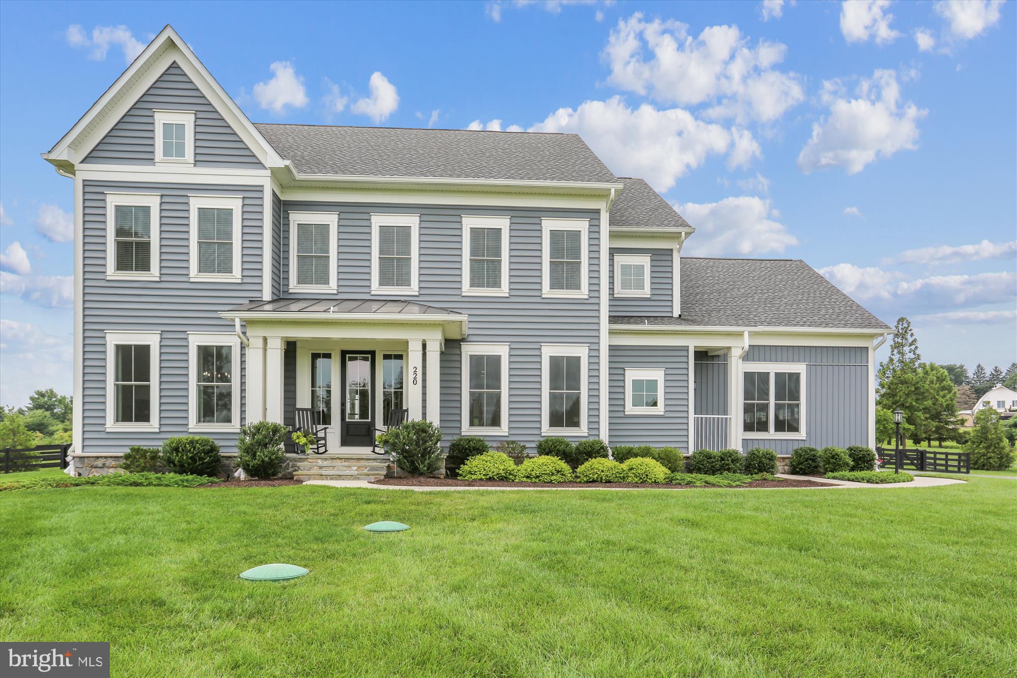 PICTURE PERFECT! This stately home is nestled on a 1.5 + acre premium lot in the sought after Laytonsville Grove, a subdivision of luxury, estate homes. Warm and welcoming, 220 Barberry Lane is notable for its high-end finishes and custom decor. Featuring high ceilings, hardwood floors, custom lighting throughout and more, no attention to detail was spared in the design of this home.
The first level features a welcoming foyer, living room with board and batten box molding and recessed lights, and a formal dining room adjacent to the butler's pantry which includes a wet bar, wine/beverage refrigerator and a custom pantry with closed cabinets and floor to ceiling shelves. The gourmet kitchen with upgraded appliance package features a center island, a gas cook top, quartz counters and an abundance of cabinets. The cozy breakfast area off of the kitchen opens up to the covered back porch. The sizable family room with coffered ceiling, gas fireplace with decorative mantel features ample windows that provide an abundance of natural light. A powder room is conveniently located off of the family room. A first floor bedroom with full bath can also serve as a den or home office. The bright and light mud room with separate entrance features a built in bench, and spacious closet. The three car garage offers smart garage doors. Delight in the scenic views one notices from every room!
The upper level features four additional bedrooms – all ensuite. The primary bedroom offers a seating area as well as an impressive bathroom featuring soaking tub, enclosed shower and two vanities. The stunning, custom dressing room/ walk in closet was recently completed and features adjustable shelves, built in drawers, moveable island, ironing board, valet bars and custom lighting. The conveniently located laundry room features built in cabinets, counter and sink.
A full-size basement (2,100+ SF) is ready for your own personal touch! The lower level has a full sized window, and rough ins for a bathroom and a wet bar.
Entertainer's delight! This custom hardscaped and professionally landscaped property offers upscale design and a bevy of features for both relaxing and entertaining. A covered porch and flagstone patio off of the family room features a ceiling fan, custom motorized shades, built in bar top with honed granite and ample seating areas. The prestigious driveway, gorgeous water feature near the patio, custom pergola in the rear of the yard and a putting green complete this one of a kind, high-end property.