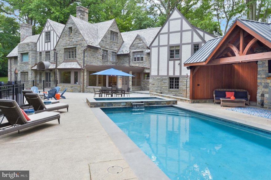 PRIVACY AND ELEGANCE!  This bright and beautiful stone Normandy Tudor Manor Home has been freshly and meticulously renovated, restored and updated over the past 3 years, blending old-world charm with today s exquisite design and craftsmanship.  Extended, private drive leads up to 2.49 acres with park-like views in all directions. Spectacular outdoor luxury includes new pool, hot tub, and pool house w wall-mounted tv and stone fireplace; gas fire pit and poolside gas lamps.  Additional stunning improvements include (not limited to):  gorgeous new state-of-the-art, gourmet Sub-Zero/Miele kitchen with honed marble countertops, stainless appliances, reclaimed wood and beautiful hardwood floors; elegant 2-room powder room is brand new and tastefully renovated, along w Master Bath and 2nd floor hall bath; master bedroom suite re-designed with en-suite master bath, radiant floor heat, reclaimed wood and large walk-in closet; select slate roof  tiles (from Ireland) refurbished along with all new copper flashing, gutters and downspouts; entire interior newly painted with neutral color palette; exterior painted 2020; classic hardwood floors t/o refinished; whole-house Sonos Sound System; all new electrical wiring and LED lighting t/o.  HVAC, hot water system newer.  1st Level: Enter grand, ballroom-like entrance hall connecting bright, open living spaces: expansive formal living room with wood-burning fireplace, opens to a sun room with custom bar.  A stunning wood-paneled library features fireplace, built-ins and access to lovely bluestone slate terrace.  Pretty powder room, breathtaking new kitchen flowing into bright breakfast room   which leads to outdoor pool and terrace area   complete this level. 2nd Level:  Ascend dramatic two-story staircase to find: 5 spacious bedrooms, 3 with en-suite full bathrooms; au-paire or in-law suite with private rear stairway from kitchen boasts 2 additional bedrooms, full hall bath and laundry room. A home office completes this level. 3rd Level:  2 additional bedrooms, full hall bath, open loft/entertainment area and large cedar closet for storage . The elegant flow of this 8,000+ sq. foot home is perfect for entertaining, family gatherings, multi-generational living   and affords plenty of private at-home work space to accommodate today s changing and evolving work-at-home environments.  Award-winning Lower Merion Schools with  Choice  school zone PLUS everything the Main Line and Center City Philadelphia have to offer.  Showings to begin 7/13/20.