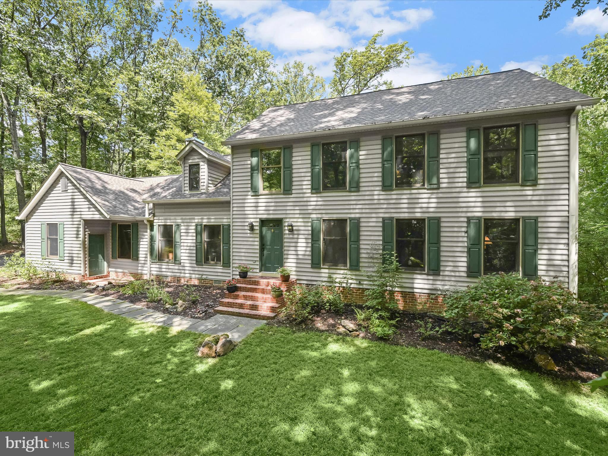 Nestled on a serene 2.04-acre wooded lot, this stunning colonial home offers a retreat-like atmosphere with the perfect blend of classic charm and modern updates. As you approach the house, a slate stone paver walkway guides you to the welcoming front door. The expansive windows allow natural light to pour in, offering breathtaking views of the surrounding woods from every angle. Step inside, and to your right, you'll find the formal living and dining rooms, both featuring brand new carpeting. The dining room exudes elegance with its crown molding and chair railing, setting the stage for memorable gatherings. The heart of the home, the fully renovated kitchen, is a chef's dream. It boasts custom soft close Alder wood cabinetry with roll-out shelves and spice rack. Beautiful granite countertops and a custom stone backsplash, meticulously crafted from individual stones, add a touch of luxury. A hammered copper farmhouse sink, perfectly positioned beneath a window, overlooks the peaceful backyard. The breakfast nook in the kitchen opens directly onto a spacious deck, making it easy to enjoy your morning coffee outdoors. Adjacent to the kitchen is the cozy family room, where a wood-burning stove with a stone surround provides warmth and ambiance on cooler evenings. The family room seamlessly flows into a screened porch with a cathedral ceiling, offering an ideal spot to unwind while taking in the beauty of the surrounding nature. The large deck off the porch overlooks the tranquil trees and expansive backyard, perfect for outdoor entertaining. Upstairs, the primary bedroom is a private sanctuary, offering ample space and serenity. The ensuite bath has been tastefully renovated with a custom oak double vanity topped with quartz, complemented by wood-look tile flooring. Three additional bedrooms share a remodeled full bath, providing comfortable accommodations for family or guests. The partially finished lower level, with walkout access to the backyard, offers versatile space that can be used as an exercise room, recreation area, or for additional storage. A side-loading, two-car garage includes steps leading to a spacious storage room above, providing additional convenience and functionality. Modern conveniences include a dual-zoned HVAC system, one installed in 2022 and one installed in 2015, with Wi-Fi-enabled thermostats, ensuring comfort throughout the year. Additional updates include a new driveway and a new roof, both installed in 2023, adding to the home's appeal and longevity. This colonial home is more than just a residence; it’s a tranquil escape, thoughtfully updated to provide comfort and style amidst a beautiful natural setting. Note: House is zoned for the new Severn Run High School.