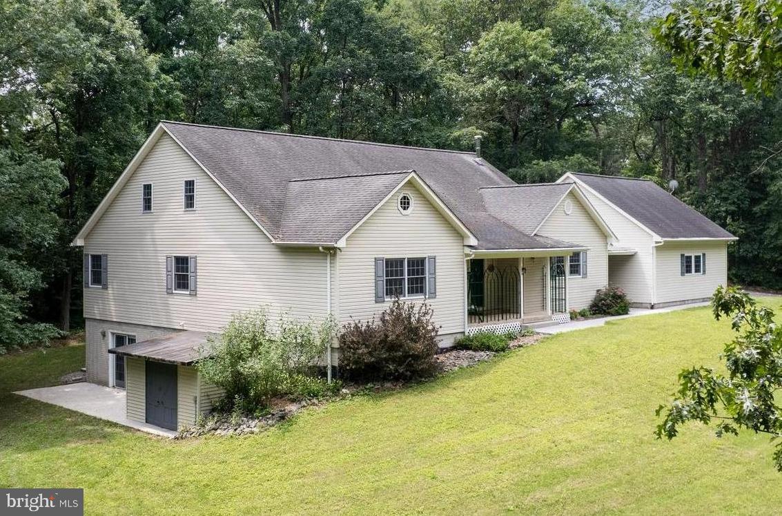 Expansive, energy-efficient retreat on 2.55 serene acres! Crafted in 1995 and meticulously maintained, this 5-bed, 3-bath residence offers nearly 4,000 finished sq ft with an easy main-level living option and abundant flex space upstairs and down. Inside, two-story and cathedral ceilings, rich laminate-plank floors, and over-sized windows brighten an open country kitchen, family room, and dining area, while pellet and wood stoves add cozy character and supplement the economical geothermal HVAC system.
Three bedrooms and two full baths are conveniently situated on the main level—including an expansive suite with a spa-style soaking tub—while the upper-level hosts two large bedrooms, a full bath, and generous walk-in closets. A roughed-in fourth full bath on the upper floor presents a great opportunity for future expansion. The walk-out lower level features a partially finished rec room, workshop area, and ample storage, inviting future media, hobby, or multigenerational spaces.
Outdoors, enjoy a rare blend of privacy and convenience: the landscaped parcel backs to mature woods at the end of a quiet cul-de-sac in Waterford Hills, just minutes from Westminster amenities. An asphalt drive leads to an attached 2-car garage, an attached carport, and a separate 24' × 24' detached garage—ideal for contractors, car enthusiasts, or extra storage. Covered porches, play area, and multiple outbuildings create room to garden, work, and unwind.
High-speed cable internet, 400-amp electric service, and well/septic sized for five bedrooms make everyday living effortless. With its spacious layout, quality construction, and peaceful setting, this home offers the perfect canvas for adding your own finishing touches. Schedule your private tour and experience the possibilities!