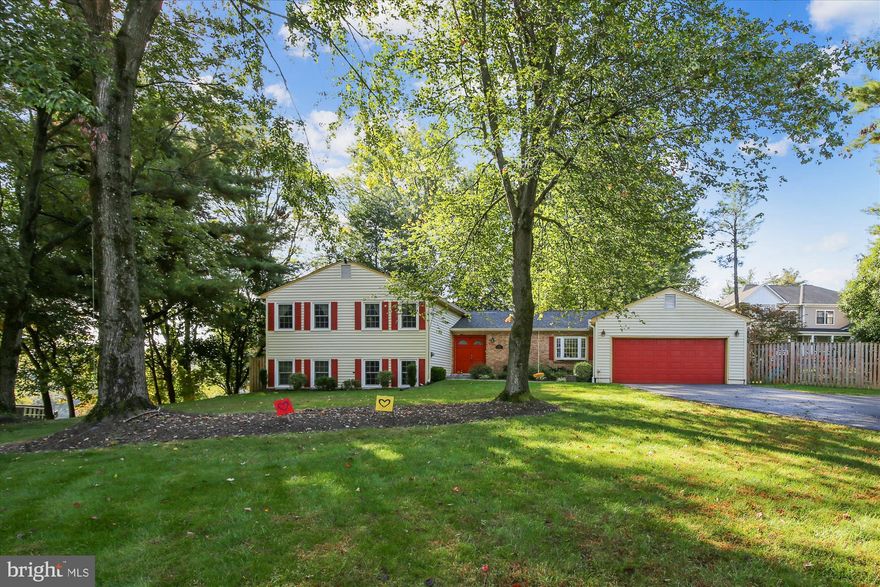 A sun-filled four level split with nearly 3000 sq ft on almost a flat half acre. with a 2-car garage. Upon entering the home, you’ll notice a welcoming foyer with coat closet and double doors. The main level features an update kitchen with 42″ cabinets, granite counters, stainless steel appliances, newly installed gas line for the gas range, a bay window for an eat-in space the current owners have transformed into a mudroom. There are hardwood floors and recessed lights in the living room with a large bay window. The dining room has the same wood floors and another large bay window which leads to a spacious sunroom with glass sliding doors and screens, ceiling fan, tile floor and baseboard heat to make it usable year-round. The sunroom leads to a large wrap around patio which overlooks the flat yard with a built-in playground area and newly built shed. *The upper level features a skylight for extra daylight, hardwood floors throughout the hallway and in 3 of the 4 bedrooms on the upper level. The primary suite features a large window, walk-in closet, and renovated en-suite bath with walk-in shower and double sink vanity. There are 3 secondary rooms that share an updated hall bath with a large soaking tub, linen closet, and double sink vanity with lots of storage. There’s a linen closet outside of the primary bedroom as well. *On the 3rd level, you’ll find a large family room with a brick, wood burning fireplace that features a wooden mantel, built-in shelves, raised hearth, custom built cabinets for additional storage, display shelves and a sliding glass door to another paver patio. The same level features the 5th bedroom with carpet, recessed lights, full bath, renovated laundry room with tankless water heater, folding counter, and bonus storage. *The 4th level is a gigantic rec room space with luxury vinyl tile and recessed lights. There’s a storage cabinet, radon remediation system, and the baseboards were removed and replaced with a wall heater. The current climbing walls can convey. There’s a large window which makes this space bright and open. There is an access door for extra storage under the stairs if you need it. The HOA fee is $200/yr. The community features 110 homes with access to walk trails, a creek, and the HOA hosts social events like an ice cream party, a summer BBQ, and a Halloween party. Easy access to Wolftrap, Meadowlark, the Cross Country Trail, with easy commuter access. Some updates include: (2022) shed, (2021) both upstairs baths renovated, (2020) remodeled laundry room, installed tankless water heater, new gas range, (2019) new HVAC, expanded upper patio, (2018) renovated basement, redid primary bedroom closet, dishwasher, relined chimney, installed playset.  A full list of updates is available.