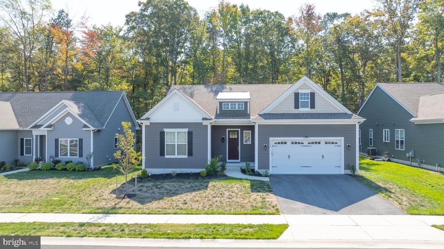 This beautiful 3-bedroom, 2-bath, 2,240 sq. ft. home on Arbor Circle offers an open floor plan in an upscale Milton community surrounded by ponds, trees, and open fields. It features a charming front porch, 2-car garage, and landscaped yard. Inside, LVP floors flow through the foyer, kitchen, and main living areas, which are filled with natural light.

The kitchen has white cabinets, stainless steel appliances, and an island with bar seating. The family room and dining room overlook a two-tiered deck and private backyard. The primary suite boasts a walk-in closet and a luxury bath with dual sinks and a glass-enclosed shower. Additional highlights include a first-floor office, laundry room, and close proximity to the community clubhouse, pool, and playground. A must-see home in Woodbridge!