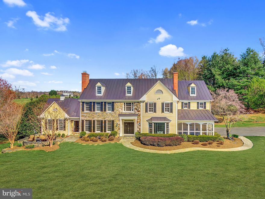 Discover the epitome of luxury country living at 15140 Loyalty Road in idyllic Waterford, Virginia.  A stately custom colonial nestled on approximately 7 acres of picturesque landscape with  breathtaking mountain and  sunset views.  Prepare to be captivated by the spacious  living space spread across three finished levels -  boasting 5 bedrooms and 7 bathrooms, each bedroom with an ensuite bathroom. The grand home features exquisite details throughout  including extensive interior millwork, refinished hardwood floors, four wood burning fireplaces, tall ceilings, a gorgeous curved staircase,  French doors and transom windows  which all add to the elegance and timeless charm.  A wonderful screened in porch connects to the living space and can be enjoyed during the Spring, Summer and Fall.  The floorpan is a blend of traditional and open concept - perfectly sized in scale to today's modern living.  The kitchen has 2 dishwashers, upscale kitchen appliances, and plenty of cabinetry and countertop space.  The dining room ties together the kitchen and formal living areas - don't  miss the large billiard room with built ins and a private exterior entrance. 
Take either staircase to the upper level which is comprised of the primary bedroom with its own private sitting room, two large walk-in closets, and  spacious primary bathroom  3 additional bedrooms each with an ensuite bathroom complete the upper level.
The finished walk-out lower level includes a private office with soundproofing,  a spacious recreational room, an additional half bath, another wood-burning fireplace and offers additional versatility and with a 5th bedroom with ensuite bathroom,  -the ideal space for guests or an au pair suite. A lLarge cedar closet and ample storage space complete the lower level.
The timeless and maintenance free exterior is constructed with native fieldstone masonry, Hardieplank siding, and a recently installed standing seam metal roof.  The rear patio encloses a generously sized  heated pool, there is an adorable playhouse, a chicken coop, and and additional flagstone terrace overlooking the front lawn.

Whether you're hosting lavish gatherings or seeking solace in your own private oasis, 15140 Loyalty Road provides the perfect setting for both. Indulge in the tranquility of nature's beauty while enjoying the comforts of luxurious living. Don't miss your chance to call this magnificent estate yours – experience a sophisticated country lifestyle beyond compare.

Nationally renowned Waterford is a testament to the will of Loudoun’s residents to preserve its historical roots, Waterford appears to be a village straight out of the colonial Mid-Atlantic.  The site of a number of mills during the 18th century, Waterford quickly grew into a major agricultural center in Loudoun County.  Today, the village and its mills remain intact and the subsequent economy has grown to serve a simple, elegant lifestyle.  In addition to its niche shops, Waterford continues to be a hub for agriculture and vineyard cultivation.  Much of the surrounding land is used for farming and raising livestock.