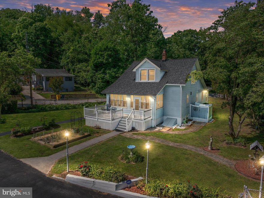 Welcome to 1101 Furnace Road, a rare retreat nestled on 1.5 private acres in the heart of Linthicum — a community where generations grow, holiday parades still bring neighbors together, and fresh produce stands mark the rhythm of the seasons. Originally built in the 1930s with enduring craftsmanship, this five-bedroom home blends timeless charm with thoughtful modern updates. The gourmet kitchen, complete with granite countertops, stainless steel appliances, and a massive center island, anchors the heart of the home — perfect for preparing Sunday dinners or gathering for morning coffee in the sunny breakfast nook. The expansive main level offers a formal dining room with an electric fireplace for cozy evenings, a spacious family room, separate living room, two bedrooms, and a full and half bath — ideal for guests or main-level living. Upstairs, three more bedrooms and a luxurious bath featuring a deep clawfoot soaking tub and sleek glass walk-in shower create a private haven. Step outside to your own personal escape — a sparkling in-ground pool, an outdoor shower, a BBQ pavilion for weekend entertaining, and even vegetable gardens for farm-to-table living. A charming screened porch with a porch swing invites you to slow down, while the detached garden studio offers space for a home office, creative studio, or bourbon tastings under the stars. With easy access to Ft. Meade, NSA, BWI, and Northrop Grumman, this one-of-a-kind property is more than a home — it’s a lifestyle.