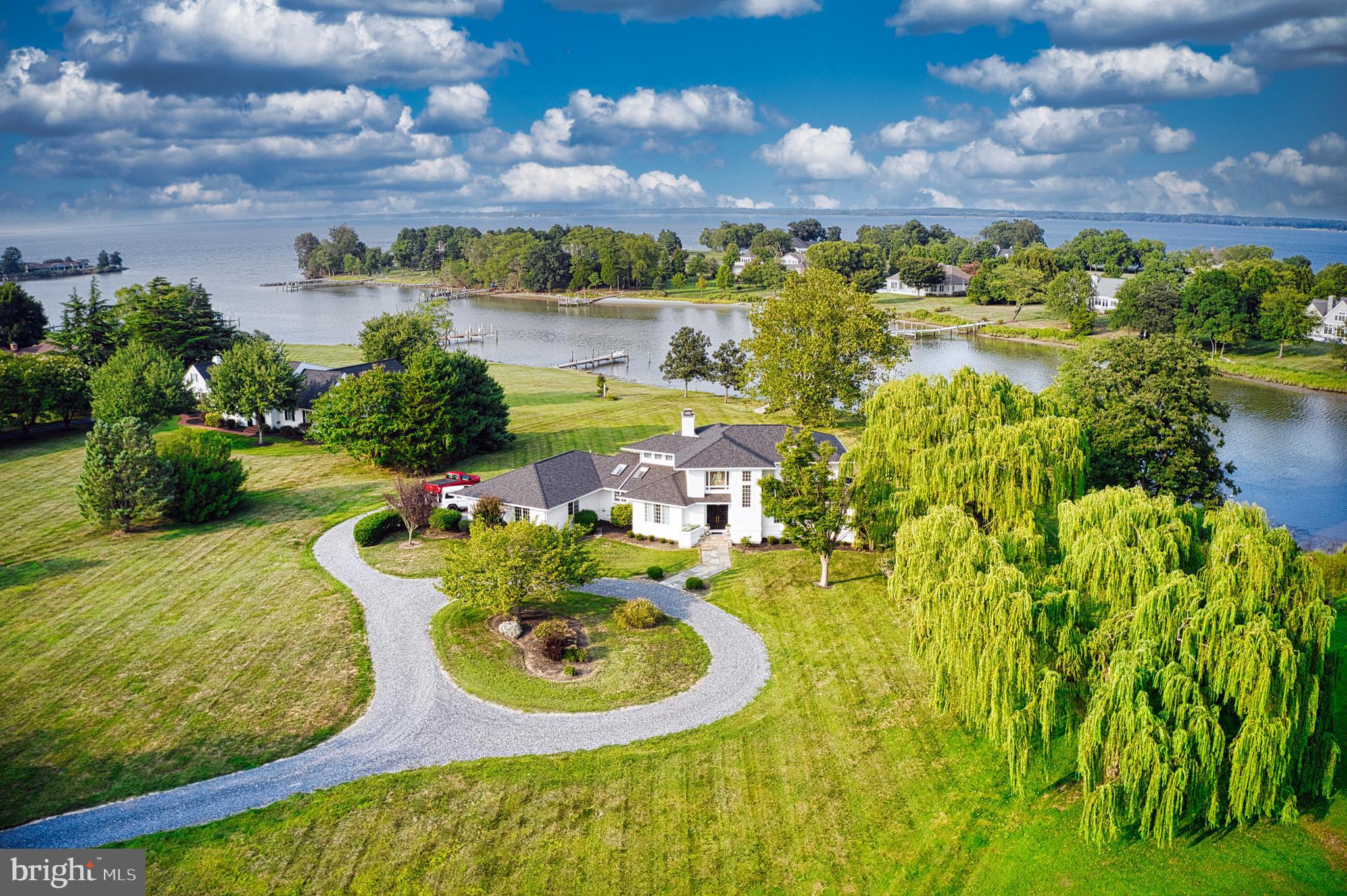 Eastern Shore contemporary with fabulous views of Hambledon Cove and the Miles River in sought after Martingham location. Enjoy proximity to golf at the Links at Perry Cabin and weekend in scenic Saint Michaels where boutiques, antique shops , favorite restaurants and coffee shops, the Chesapeake Bay Maritime Museum and the St Michaels Motor Museum await.
This home is move in ready with a beautiful lot large enough to host a pool on the water side.
Dramatic entry opening to the living room with lots of glass to frame the beautiful views.
This home was renovated in 2022 , all new flooring, bathroom , kitchen, paint inside and out, new sunroom, roof replaced in 3/2024, leaf guard, new Bryant HVAC 3/2022, new water heater, new deck in 3/2024.