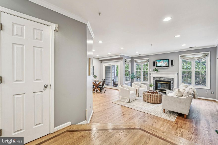 Welcome to 4681 Lawton Way #103, a beautifully updated 2 bedroom, 2 bath condo in the sought after, pet friendly Manors at Stonegate community. With 1,210 square feet of stylish, comfortable living space, this home strikes the perfect balance of warmth, sophistication, and convenience in one of Alexandria’s most desirable neighborhoods.

Step inside and you’ll immediately notice the refinished hardwood floors that flow through the open living and dining areas. The spacious living room features a cozy gas fireplace and large upgraded windows that fill the space with natural light. Just off the living room, sliding glass doors lead to your private balcony, the perfect spot to enjoy morning coffee or relax after a long day. The balcony overlooks peaceful green space, and the building itself is garden-style, offering a more private, open feel compared to a high-rise setting.

The kitchen has been tastefully updated with modern cabinetry, granite countertops, and stainless steel appliances, and the pass through window to the dining area makes entertaining easy. The primary suite offers custom designed closets and a modern ensuite bath with dual vanities and a glass enclosed shower.

Other highlights include in unit laundry with custom shelving and a newer washer and dryer, an assigned parking space (#40), and plenty of guest parking. Residents love the community’s resort style amenities, including a pool, clubhouse, serenity garden, tot lot, and walking paths. You’ll also appreciate being just minutes from Shirlington, Bradlee Shopping Center, Fort Ward Park, and major routes like I-395 for easy access to the Pentagon and D.C. It’s a rare find that combines modern updates with everyday comfort in an unbeatable location.